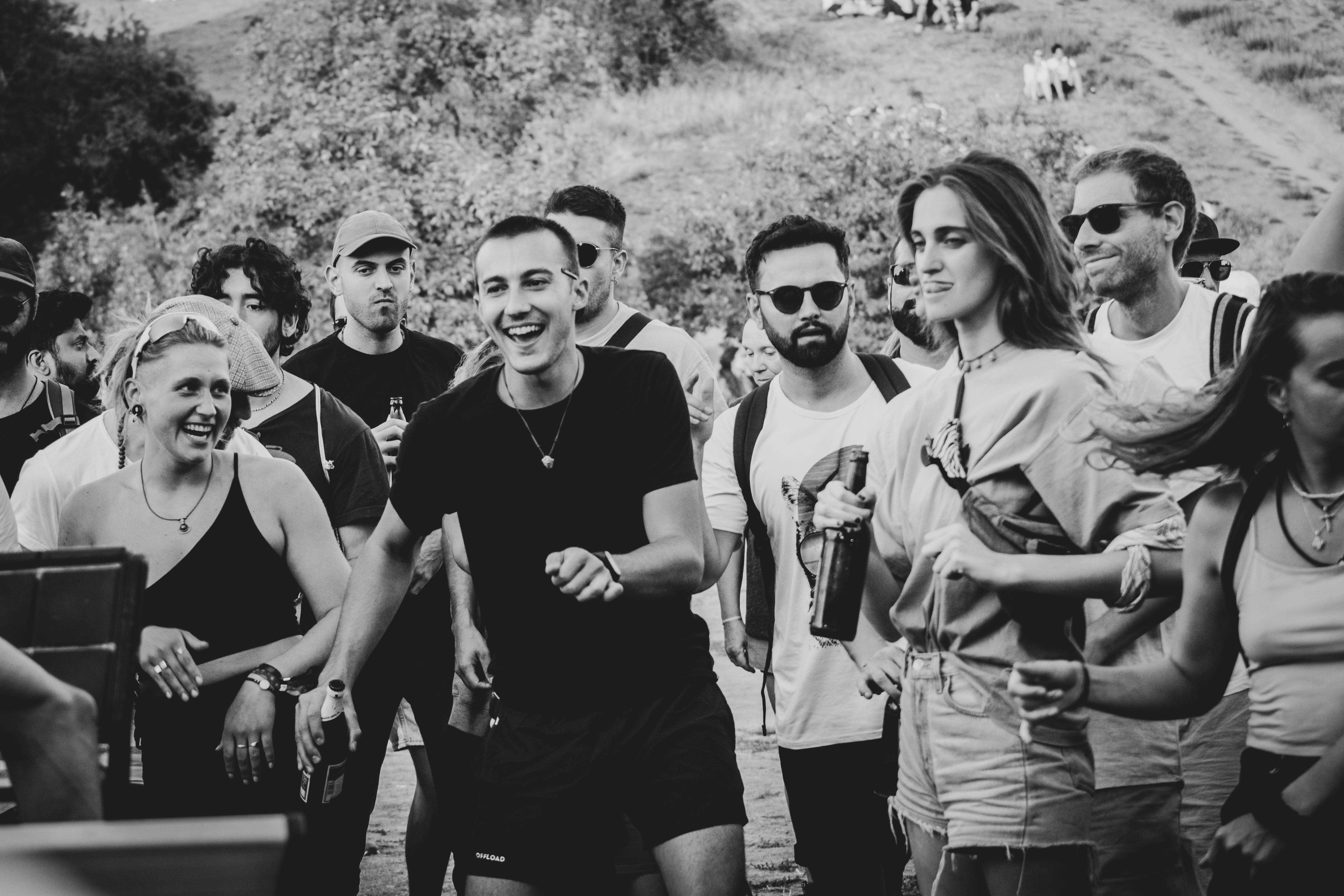 Community gathering with people dancing and moving together, reflecting embodied movement, social connection, and holistic approaches to nervous system health and pain relief.