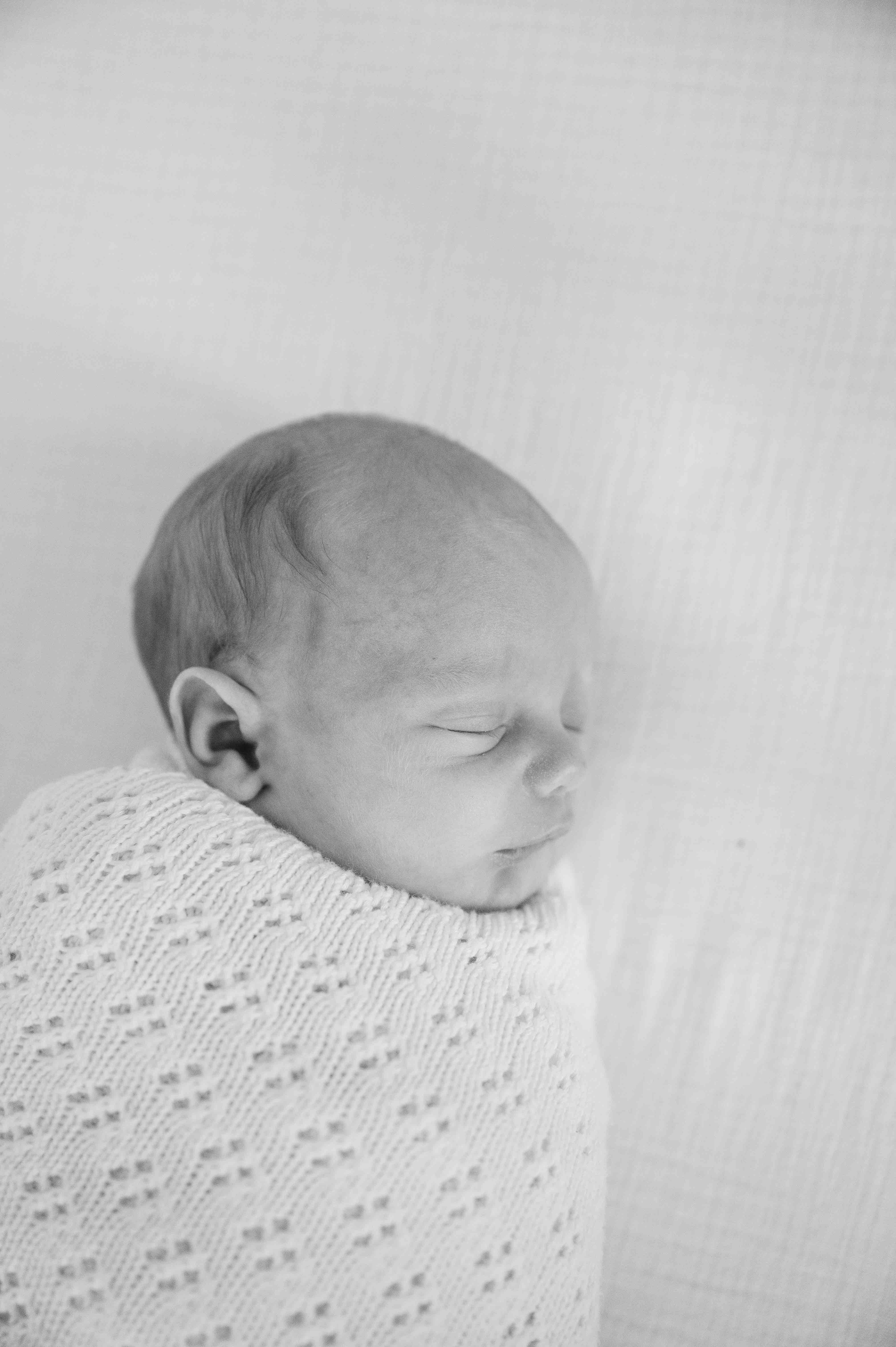 Newborn lifestyle session black and white portrait of baby.