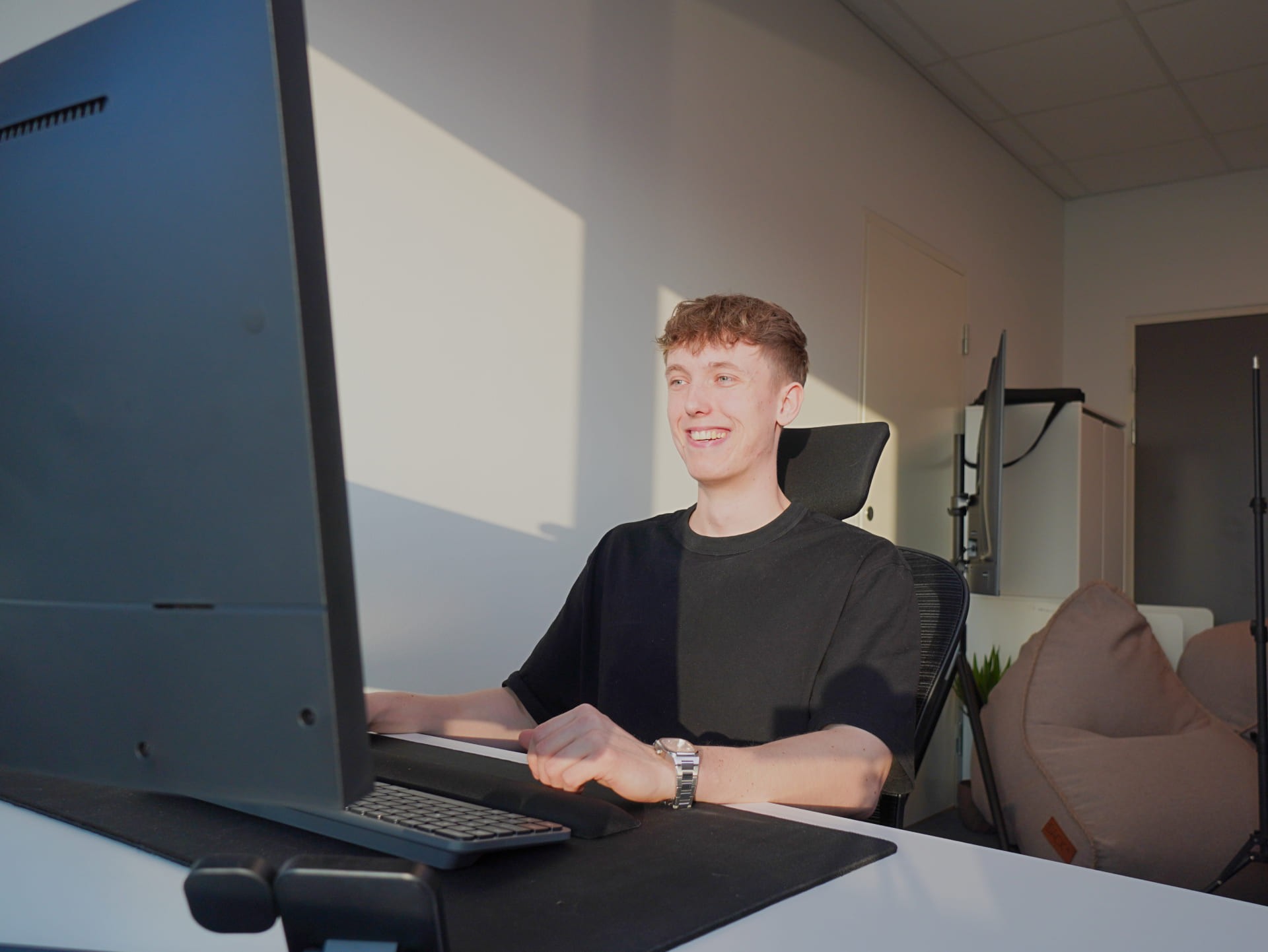 a man sitting in front of a laptop computer