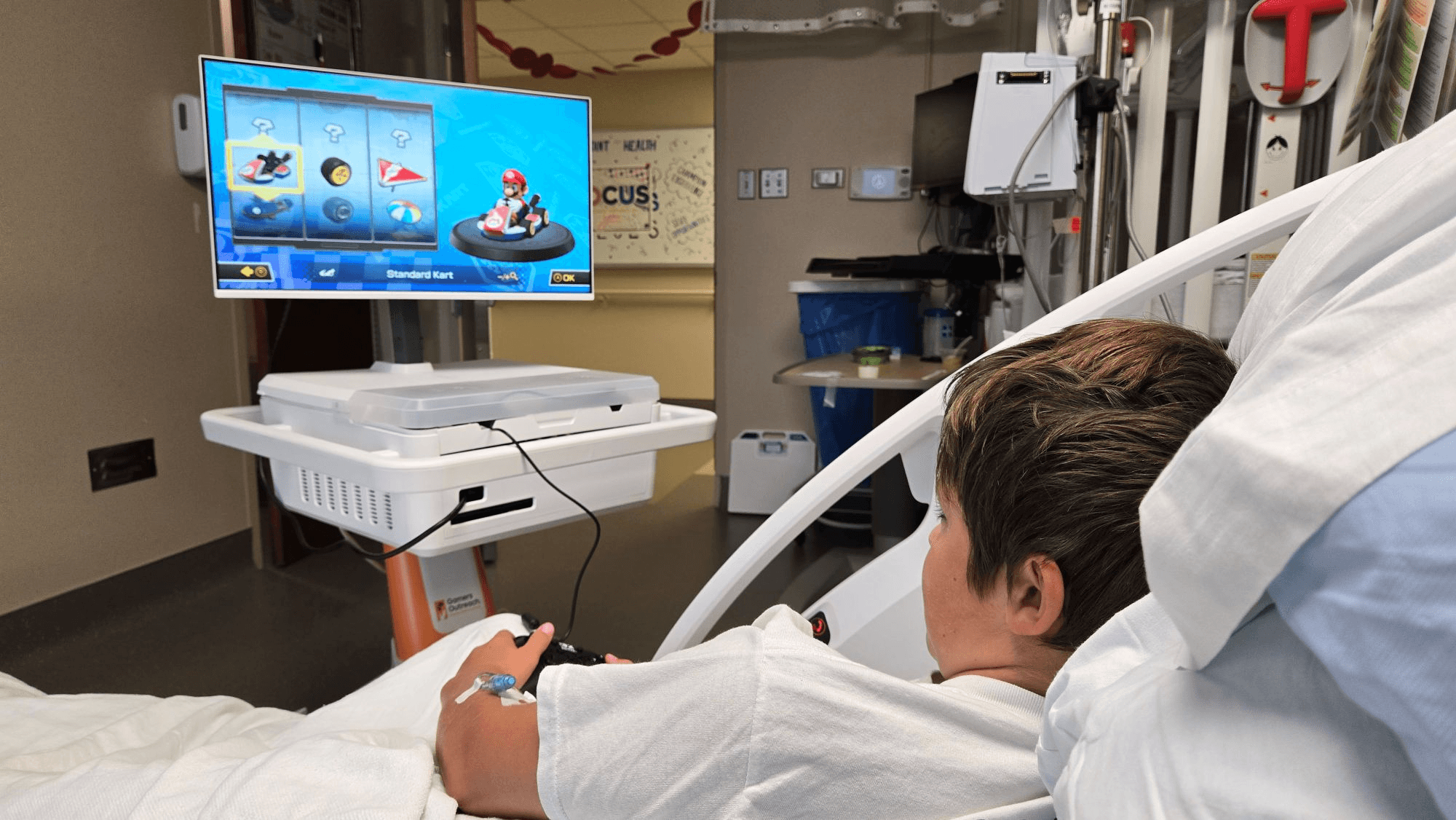 Kid playing Mario Kart on a GO Kart