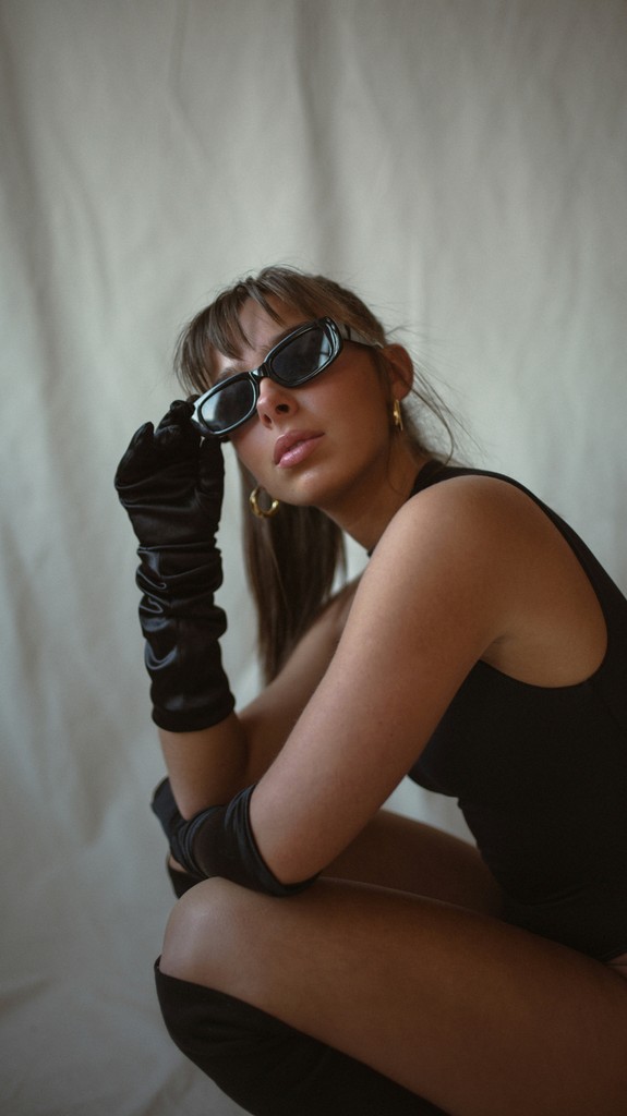 Girl kneeling with sunglasses