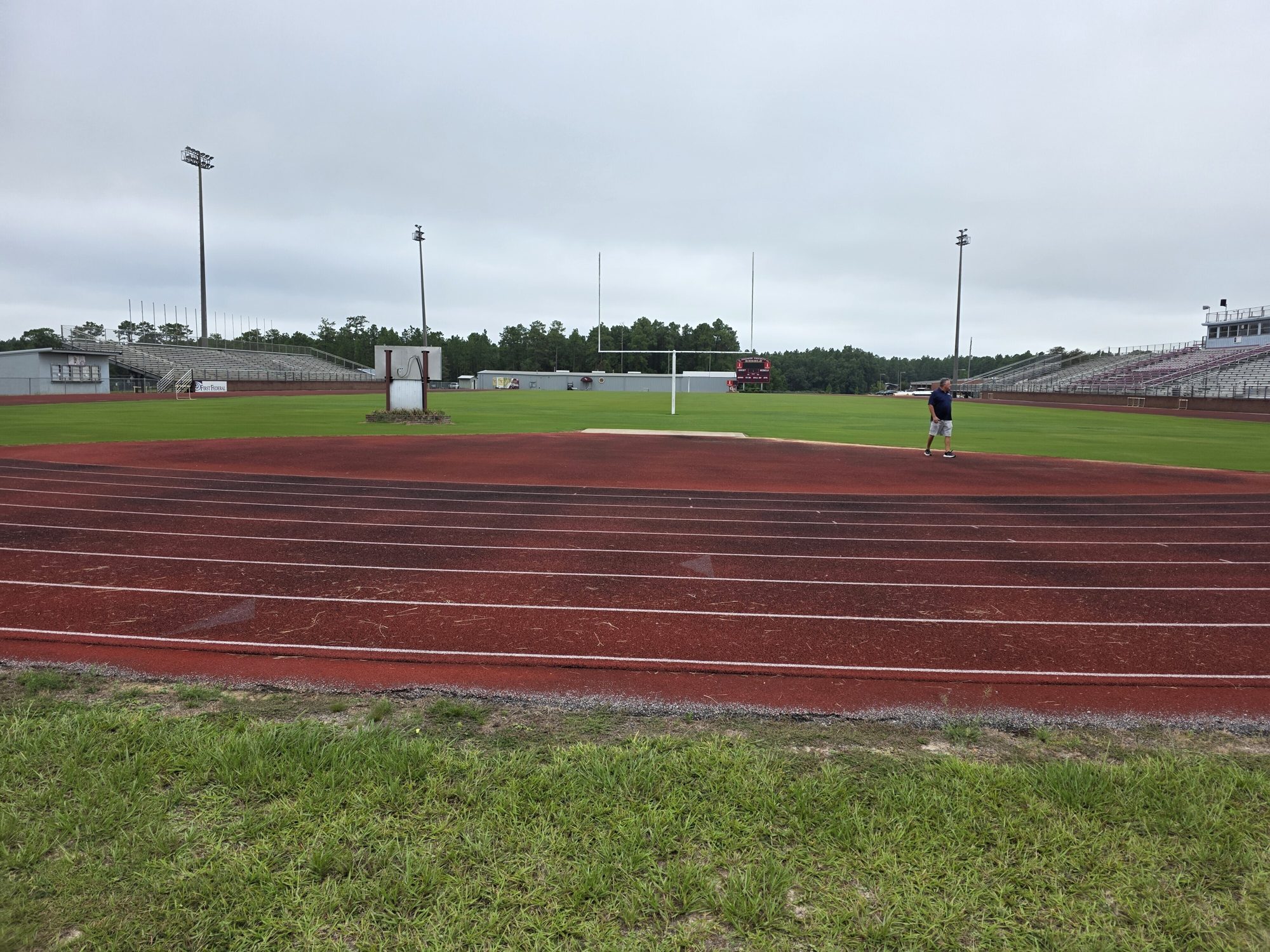 Worn track and infield before the surface replacement at George County High School in Lucedale, MS