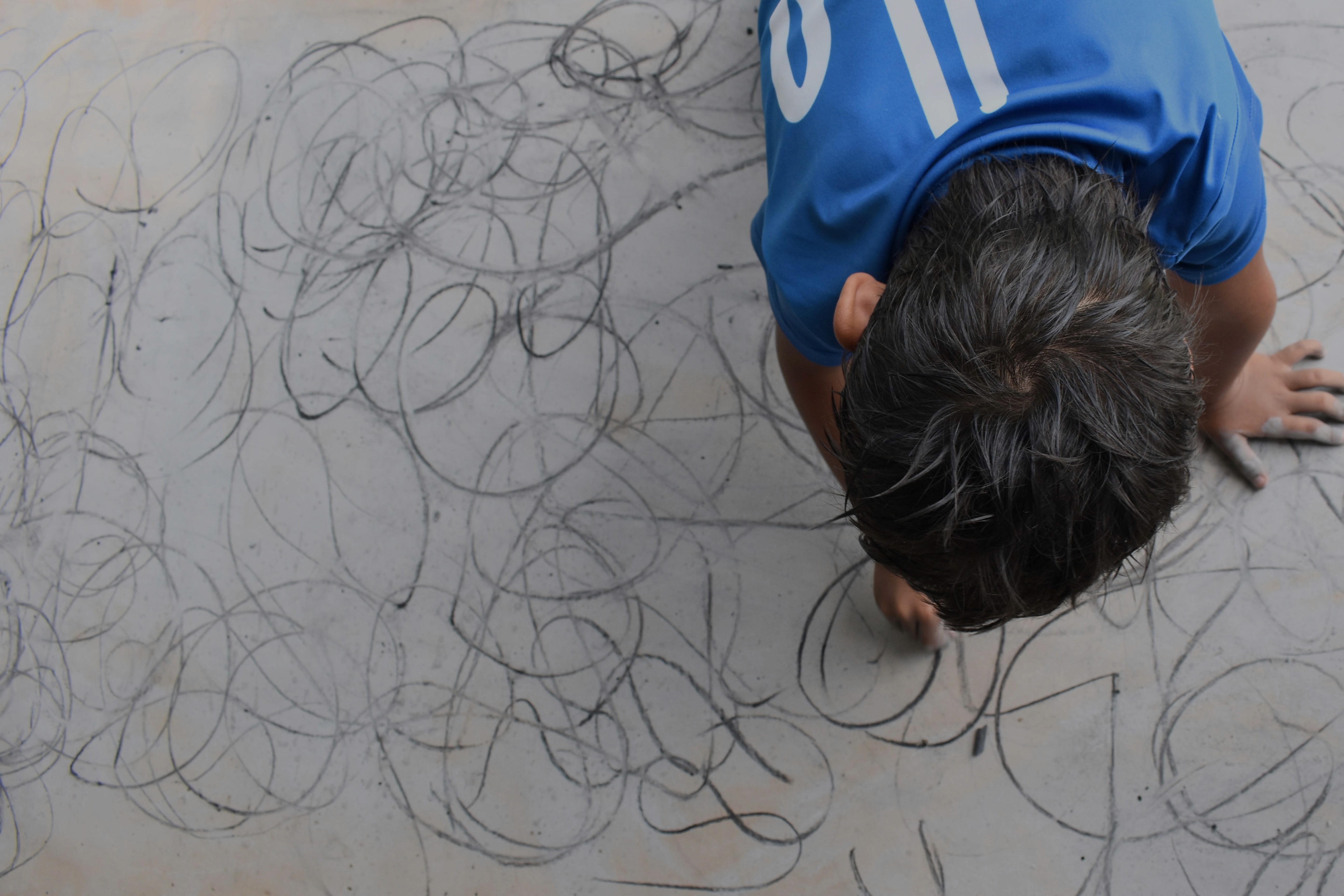 person sitting on grass and using phone