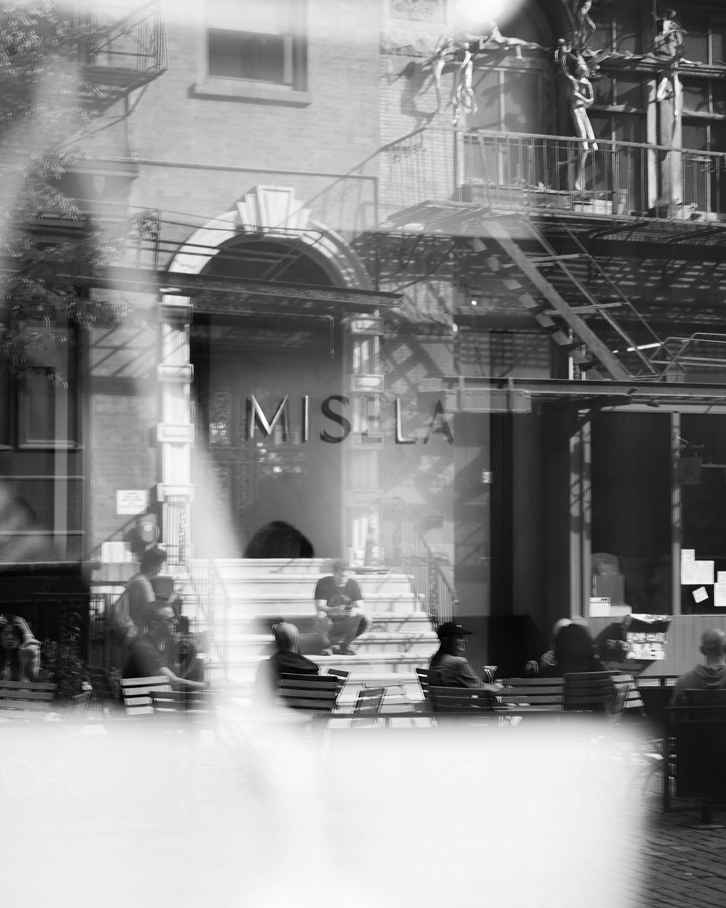Reflected street view of Misela storefront signage on Bond Street New York during the store opening.