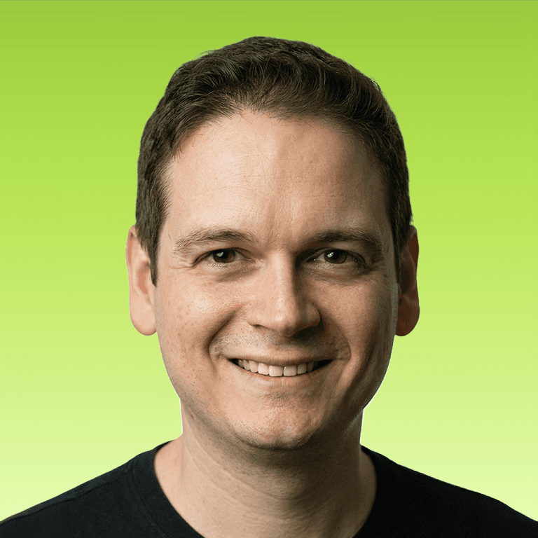 Professional headshot of Pedro Pazitto smiling against a bright green background.