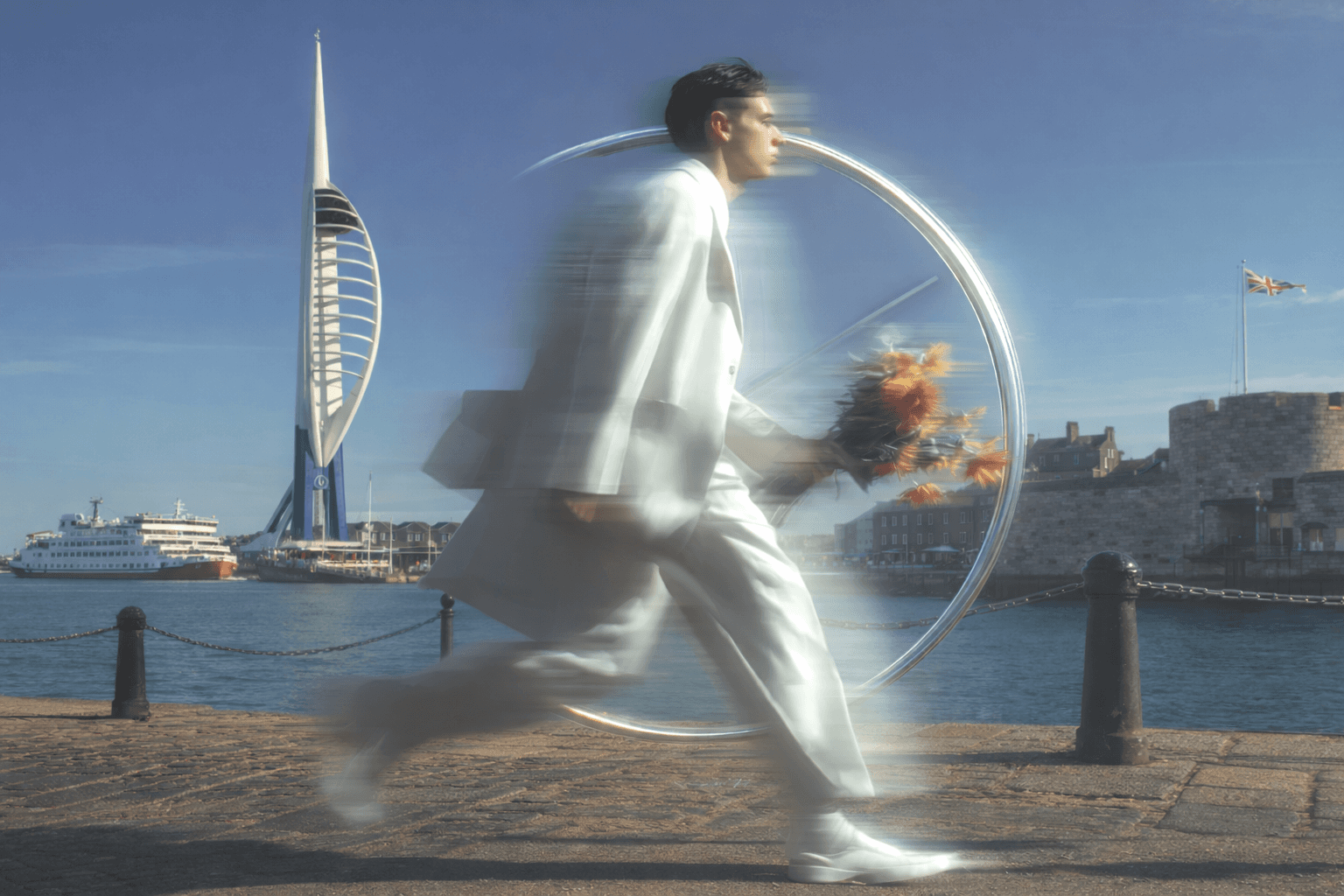 A surreal image of a person in motion, holding flowers in a field with a futuristic circular structure in the background.