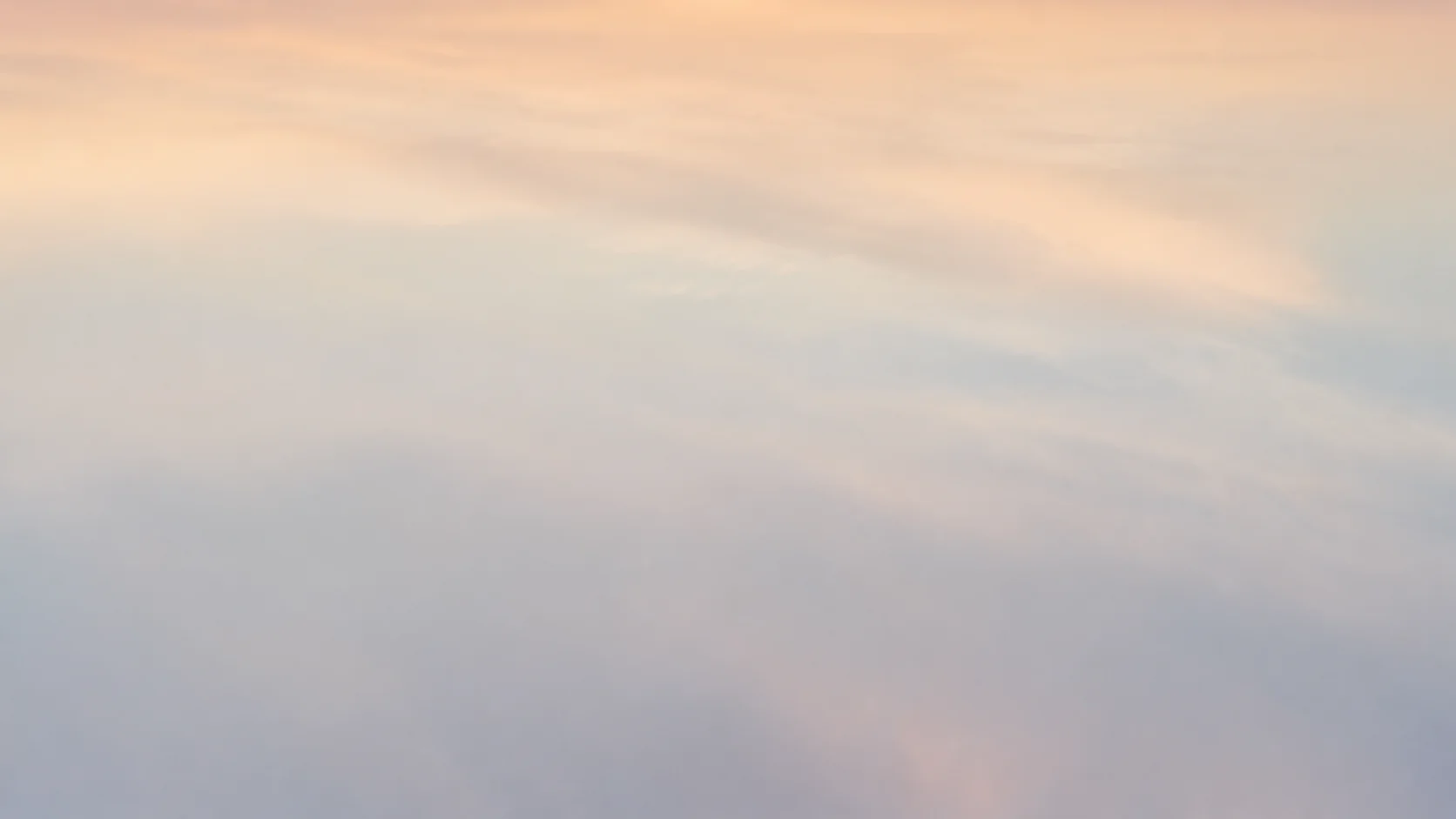 Soft gradient sky, transitioning from pale yellow to light blue, creating a serene & calming atmosphere.