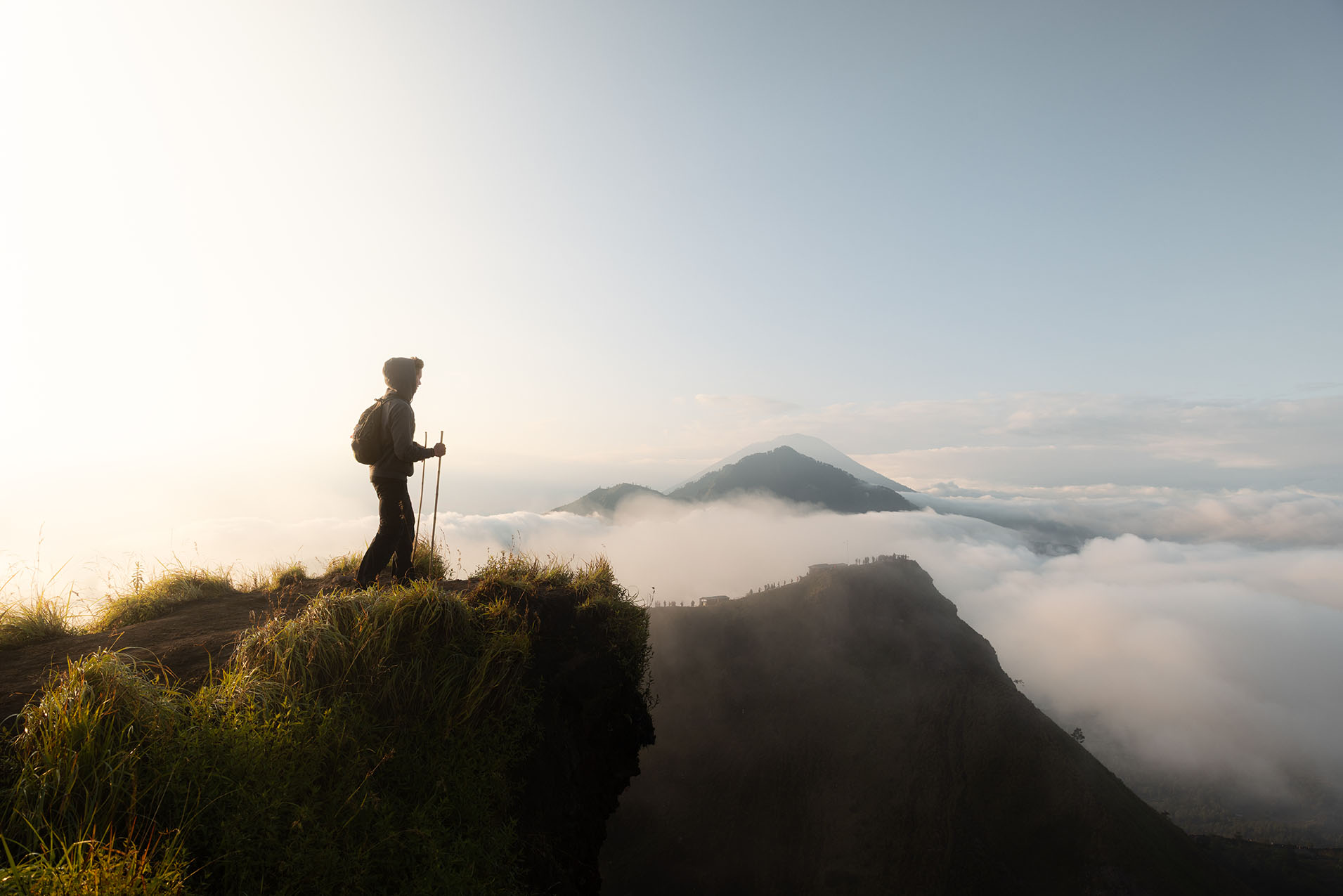 Hiker standing on the edge of Mount Batur, Bali, Indonesia at sunrise.
