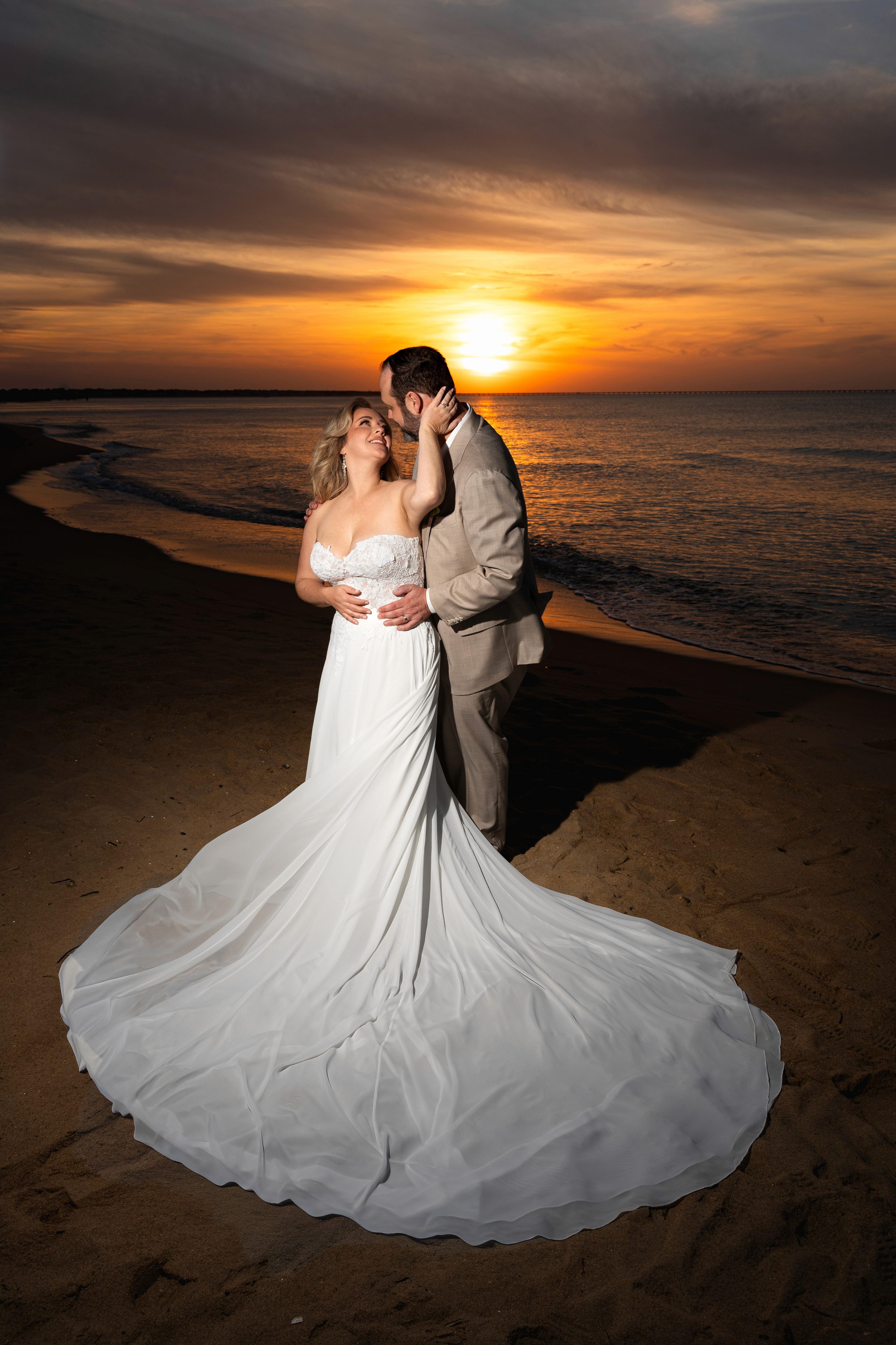 A couple stands closely in an intimate embrace.