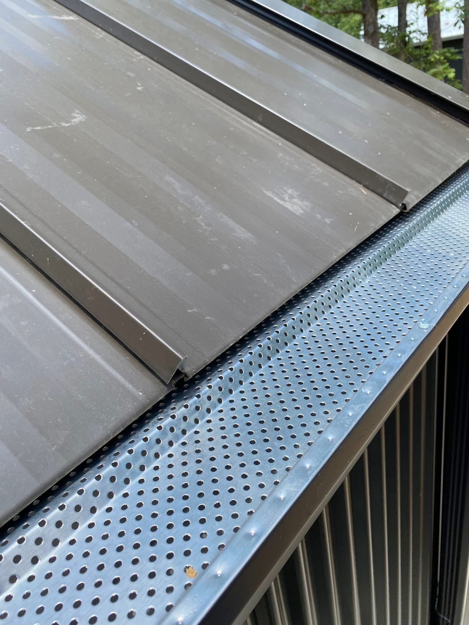 Mesh gutter guard installed above a downspout in Starkville, MS