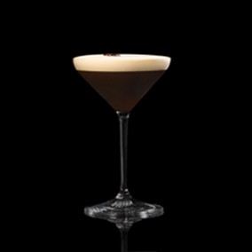 A closeup of an Espresso Martini  drink against a dark background.