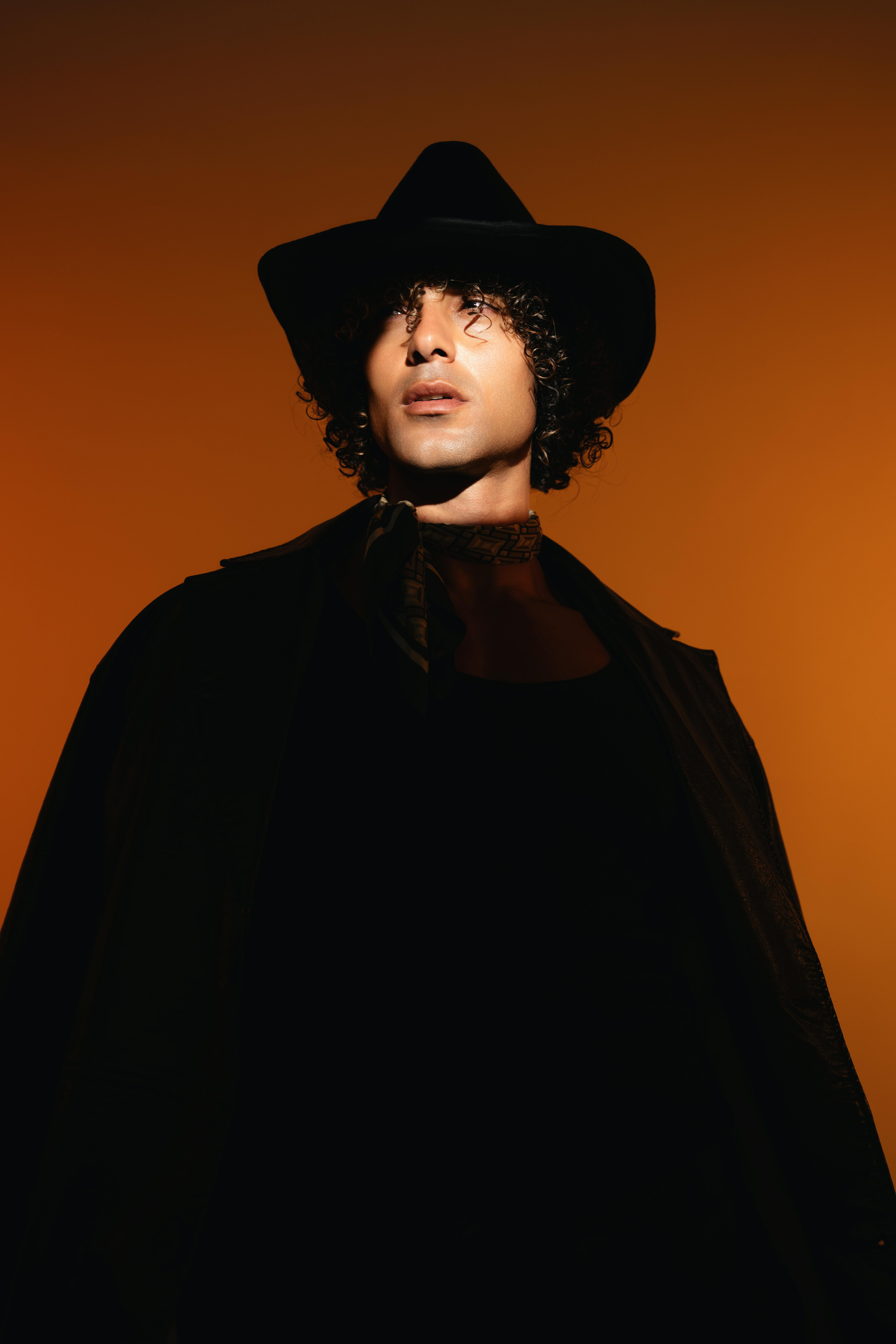 Man in western hat on orange background