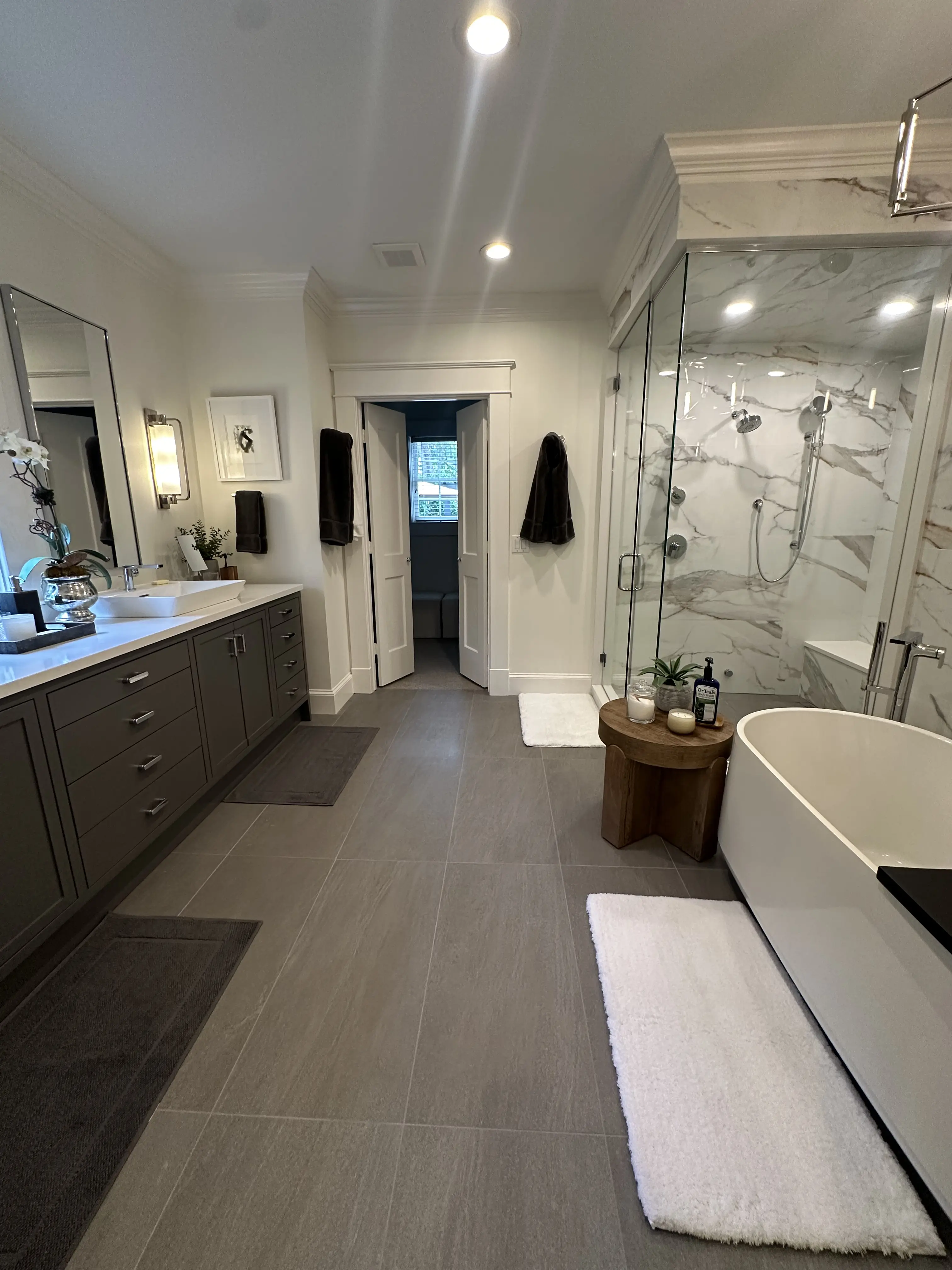 A person wearing bright green gloves is cleaning a surface with a cloth and a spray bottle.