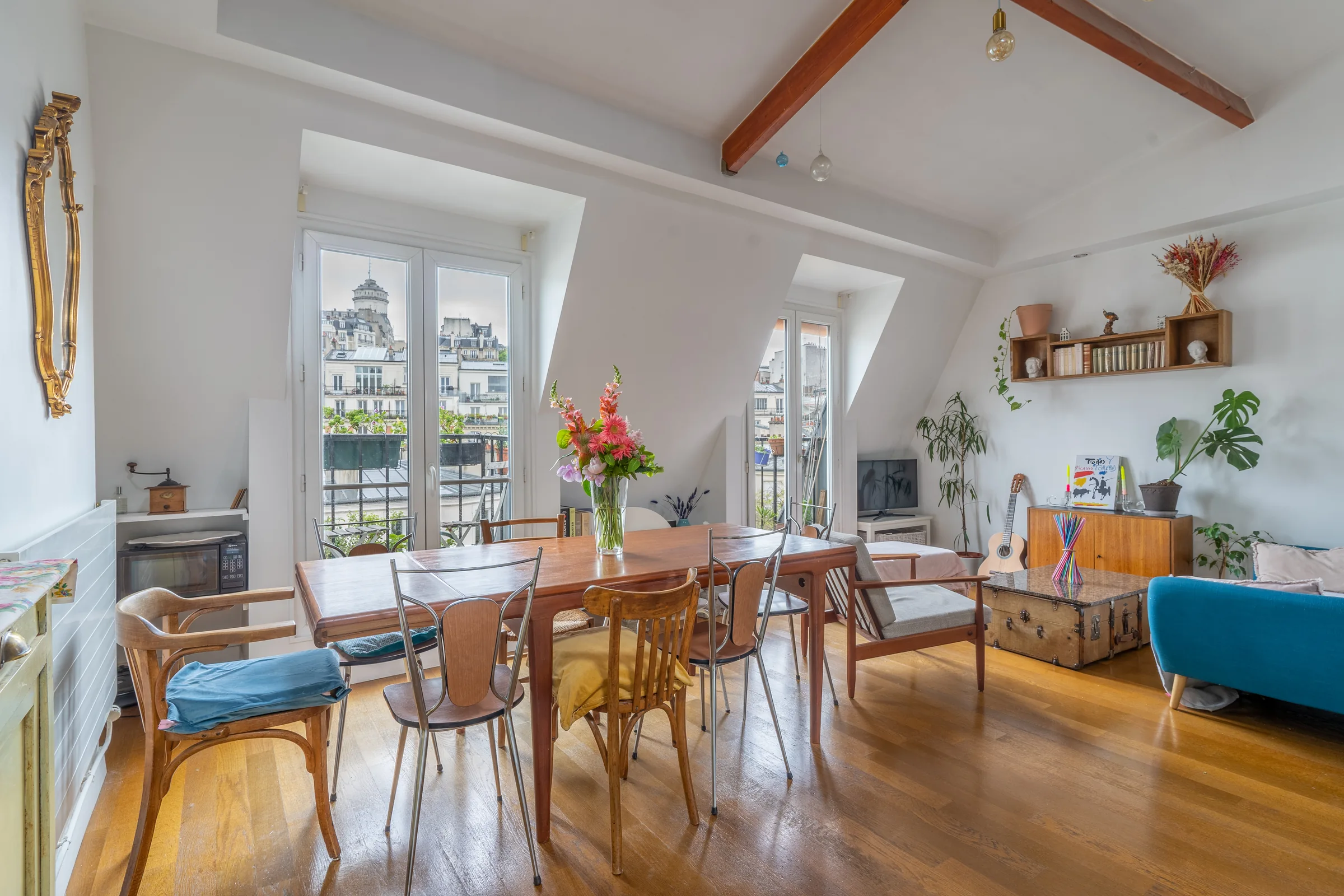 Montmartre living room with exposed beams — Paris, France. Photography by Yunes Calore.