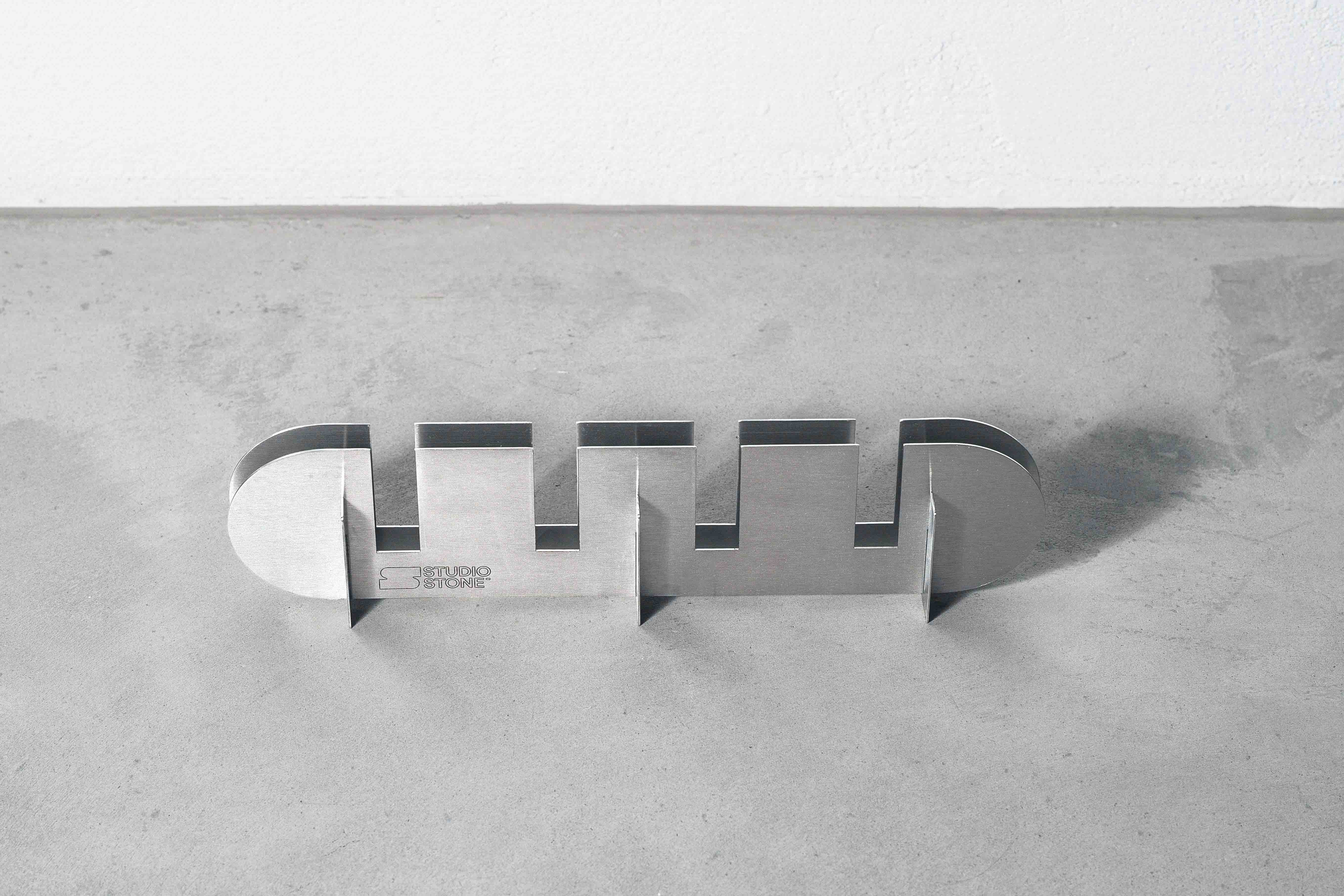 a metal candle holder on a concrete floor