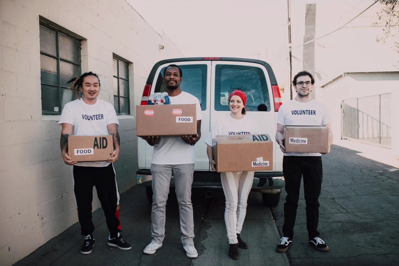 Volunteers carrying boxes of groceries for a partner food pantry
