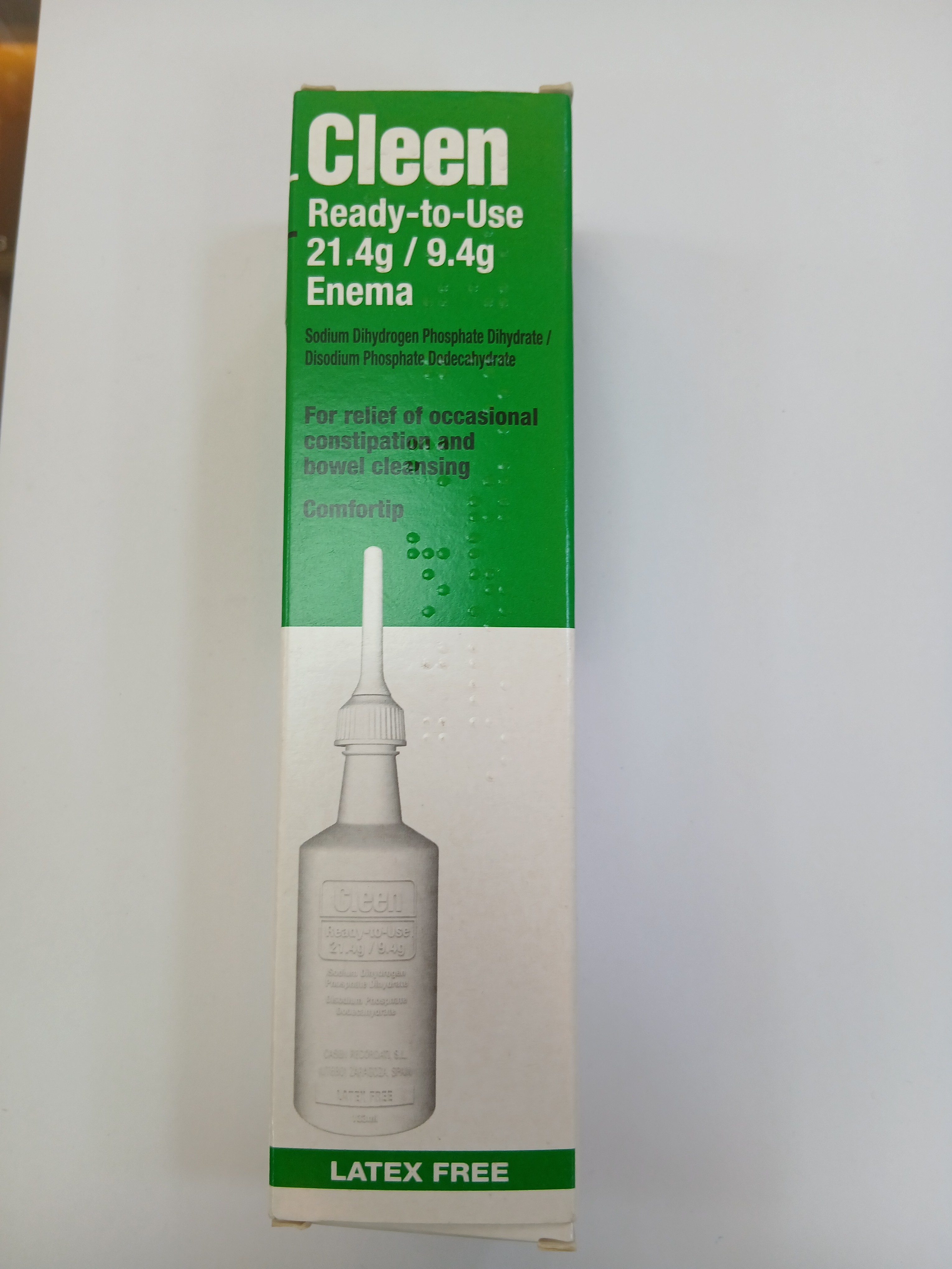 A green and white cardboard box packaging displays a latex-free, ready-to-use enema bottle with a white nozzle, indicating a 21.4 gram or 9.4 gram size.