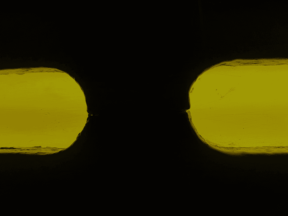 Abstract black shapes against a bright yellow background.