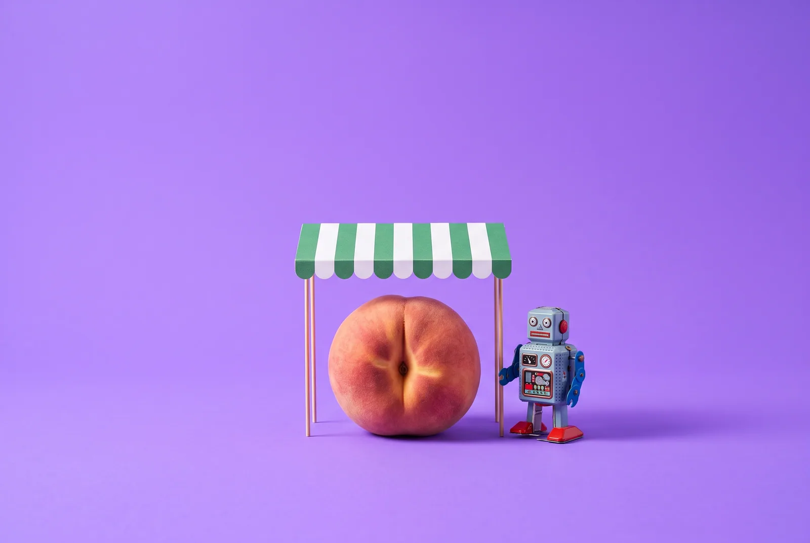 A peach under a striped awning guarded by a toy robot, a Canopy app review for QUITTR vs Canopy