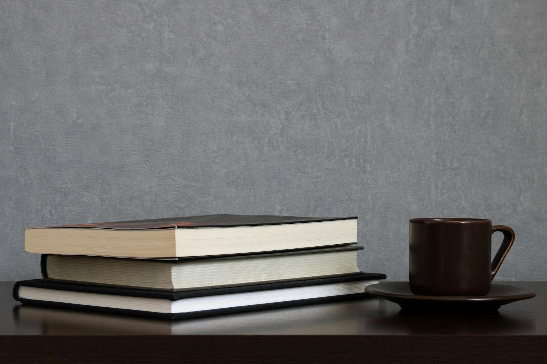 A smiling teacher sitting comfortably at a desk using a streamlined digital dashboard for efficient progress monitoring.