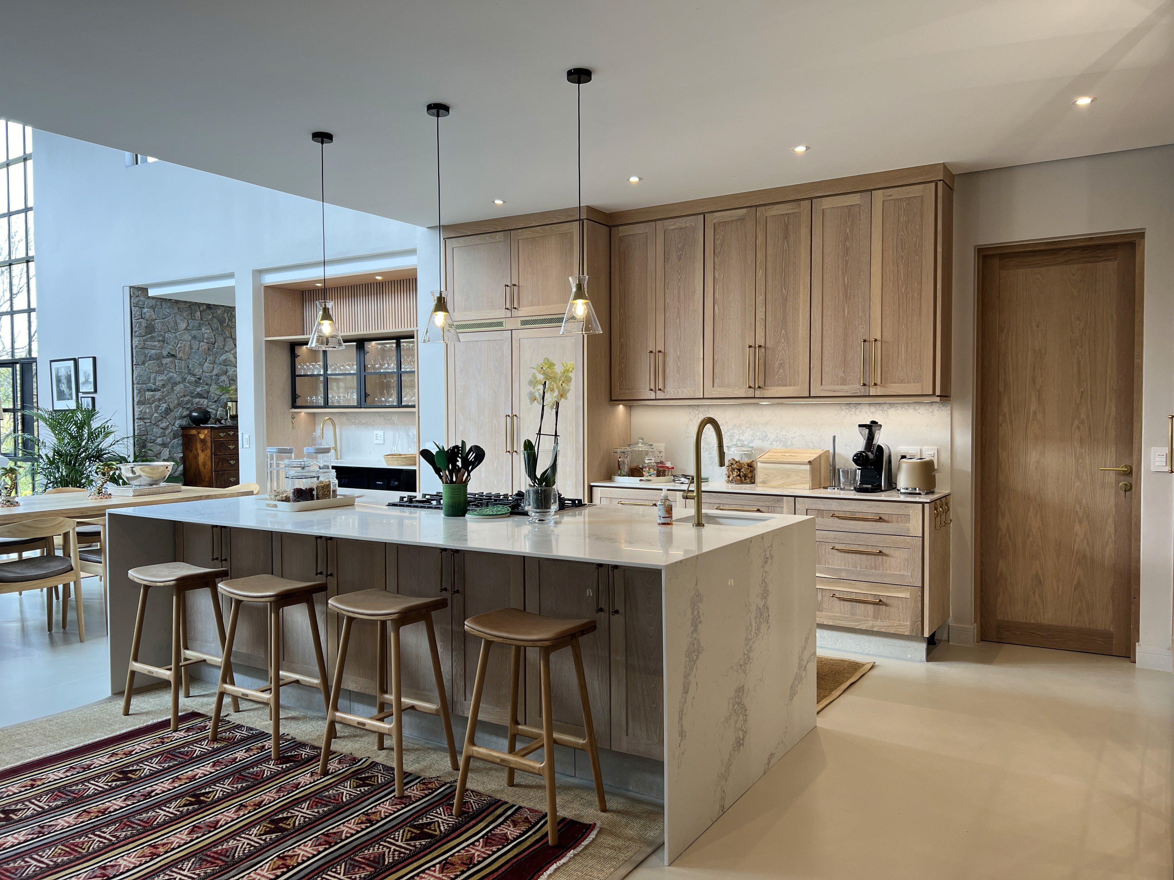 Modern timber-clad residence with horizontal wood facade and geometric volumes set on manicured lawn