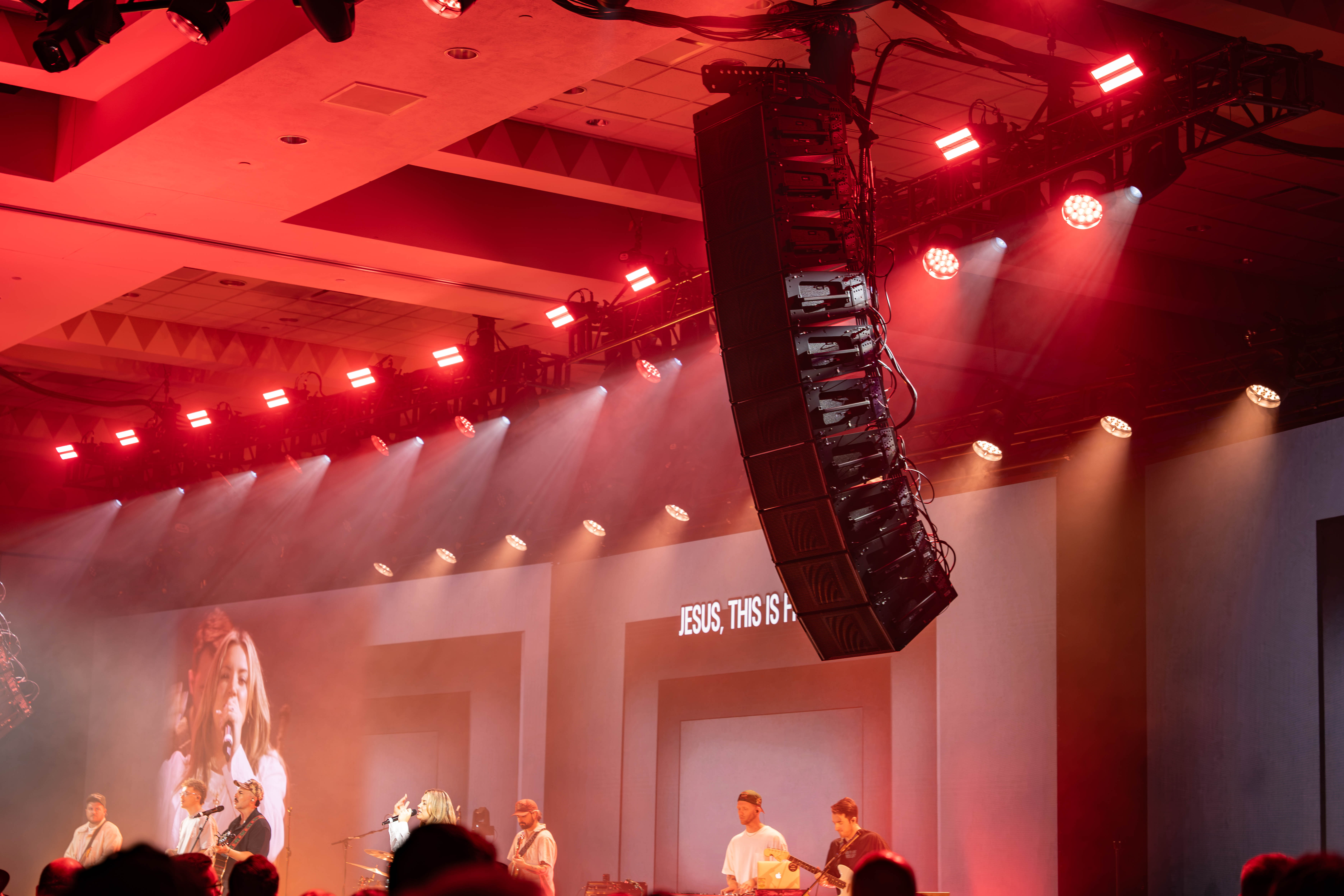 Worship service with stage lighting and video screens