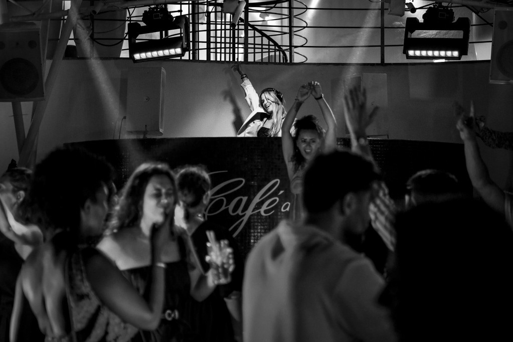 Crowd dancing at a nightclub event, black and white