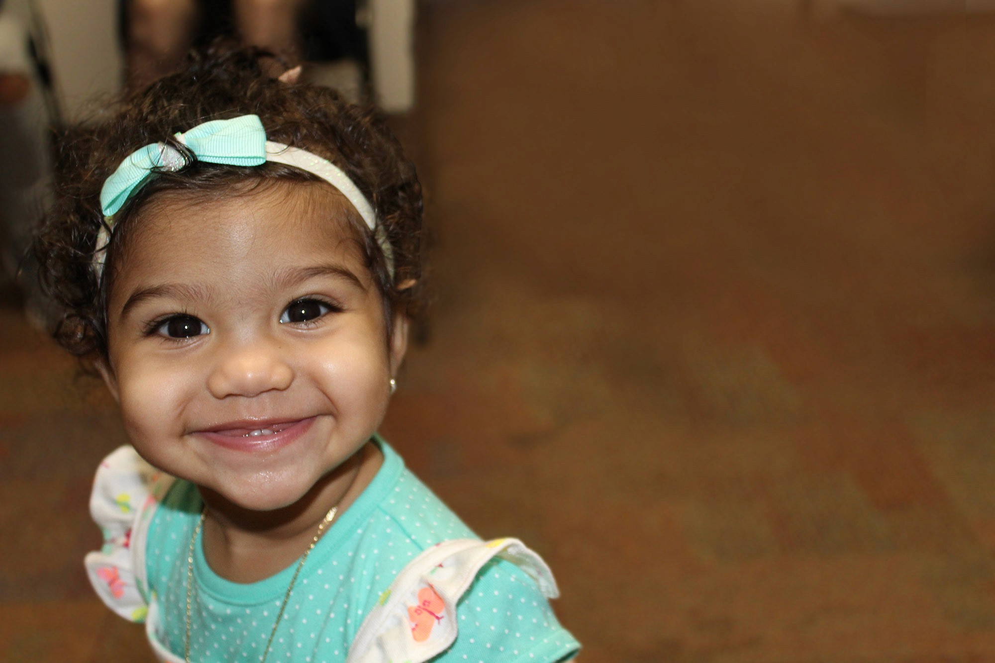 woman holding a phone and man looking at the phone. both are smiling