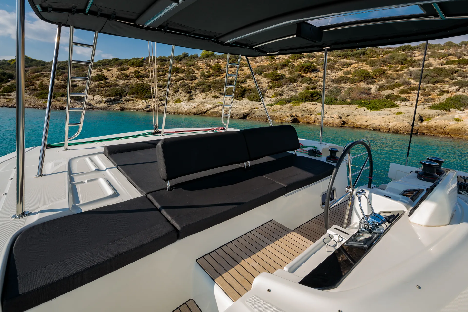 White Rock 36 speedboat with captain at helm cruising calm blue waters near Paros coastline with hills in background.