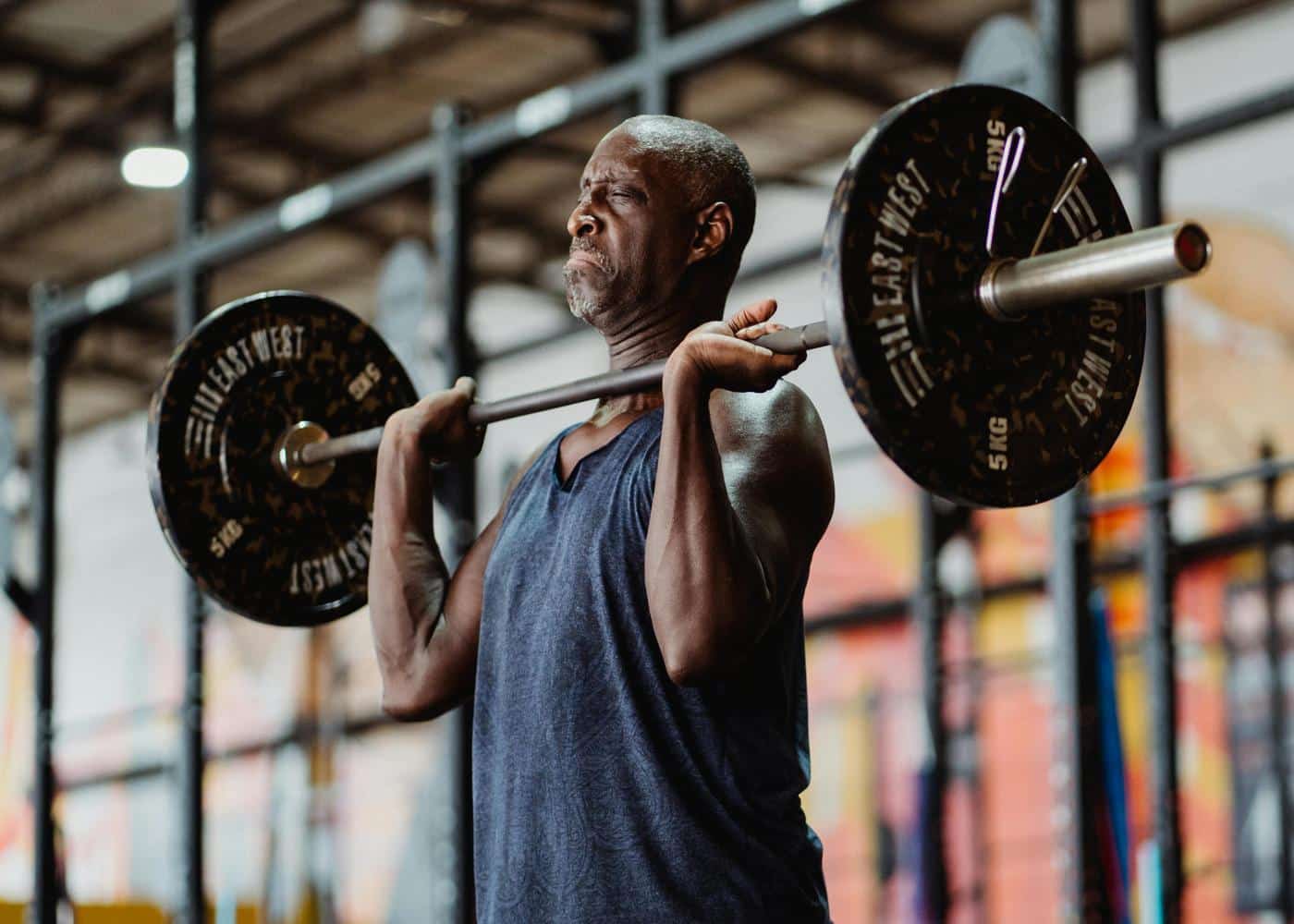 Middle aged man lifting a heavy barbell