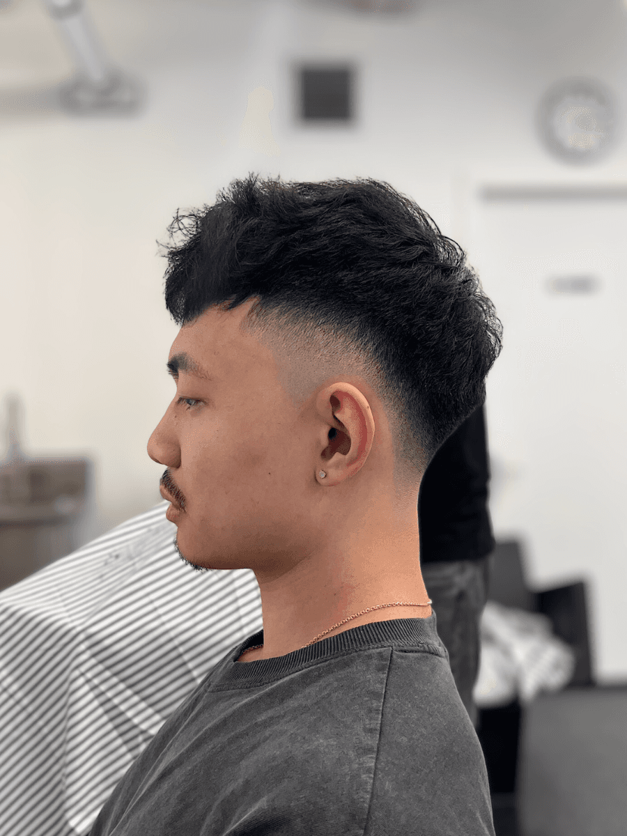 person holding white and gold hair comb