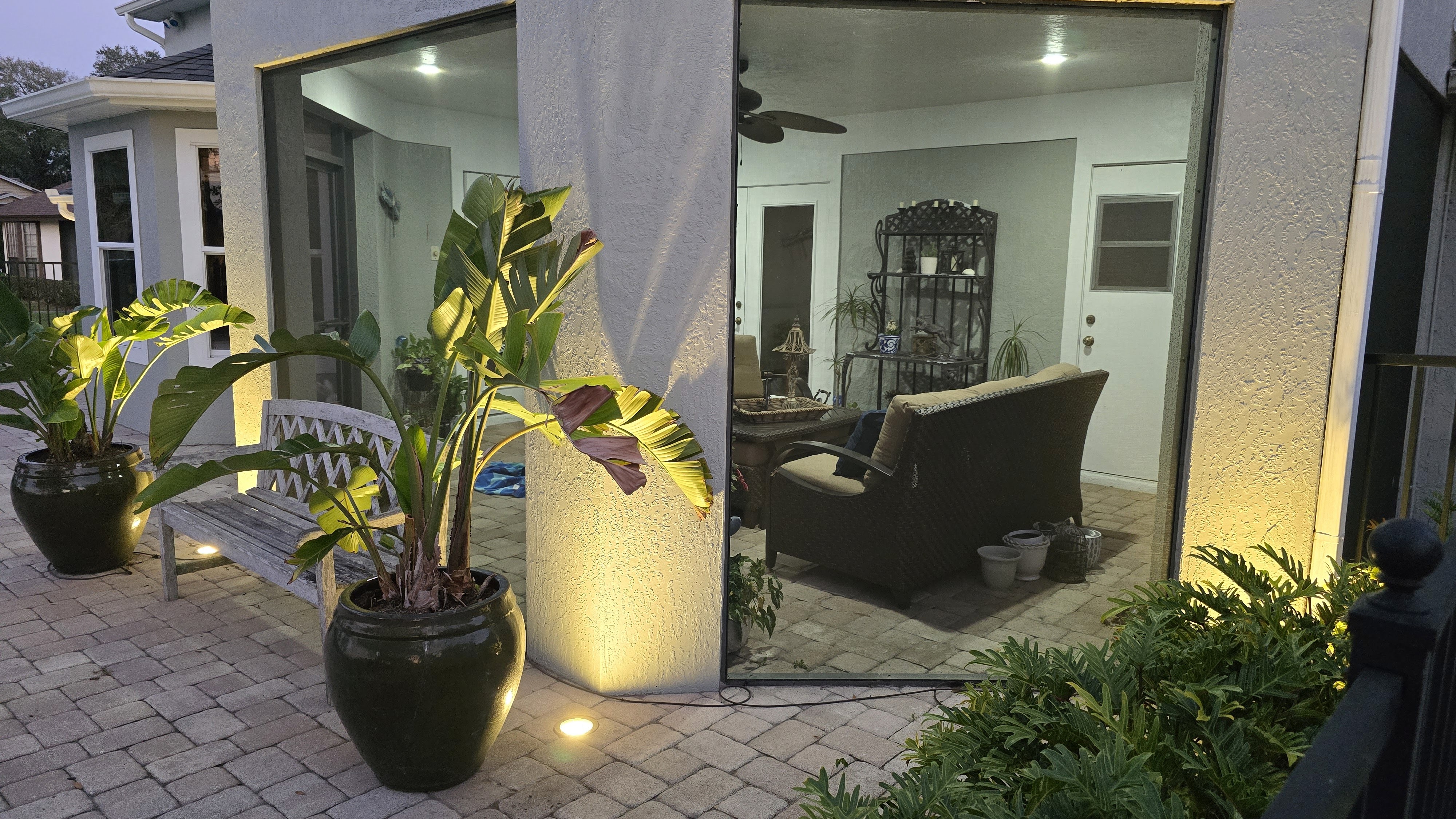 Outdoor entry seating area highlighted with architectural accent lighting