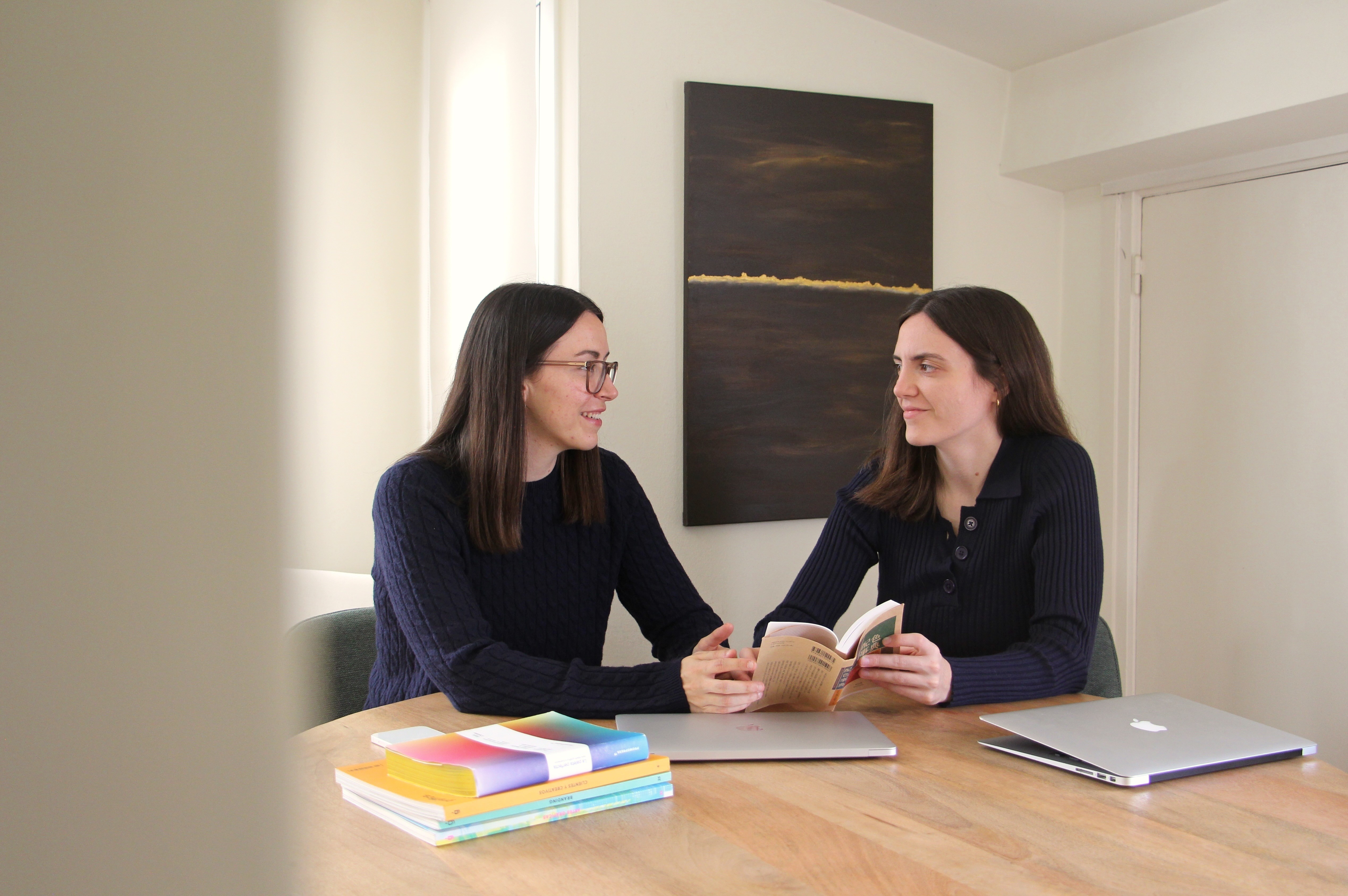 A photo of the two founders of the studio looking at each other.