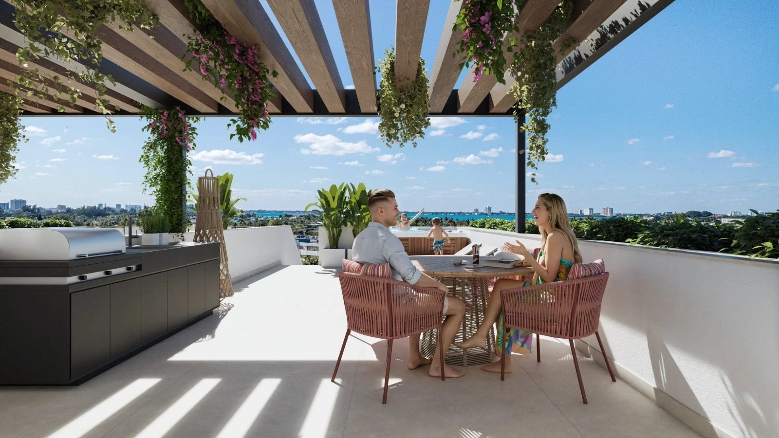 Family enjoying the rooftop terrace at Byron Avenue Residence in North Beach, Miami Beach, with pergola dining, outdoor kitchen and spa overlooking the bay