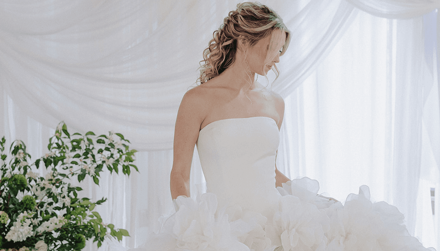 nfinity pool blending into the ocean view, minimalist sun loungers in soft neutral fabric, curved architecture