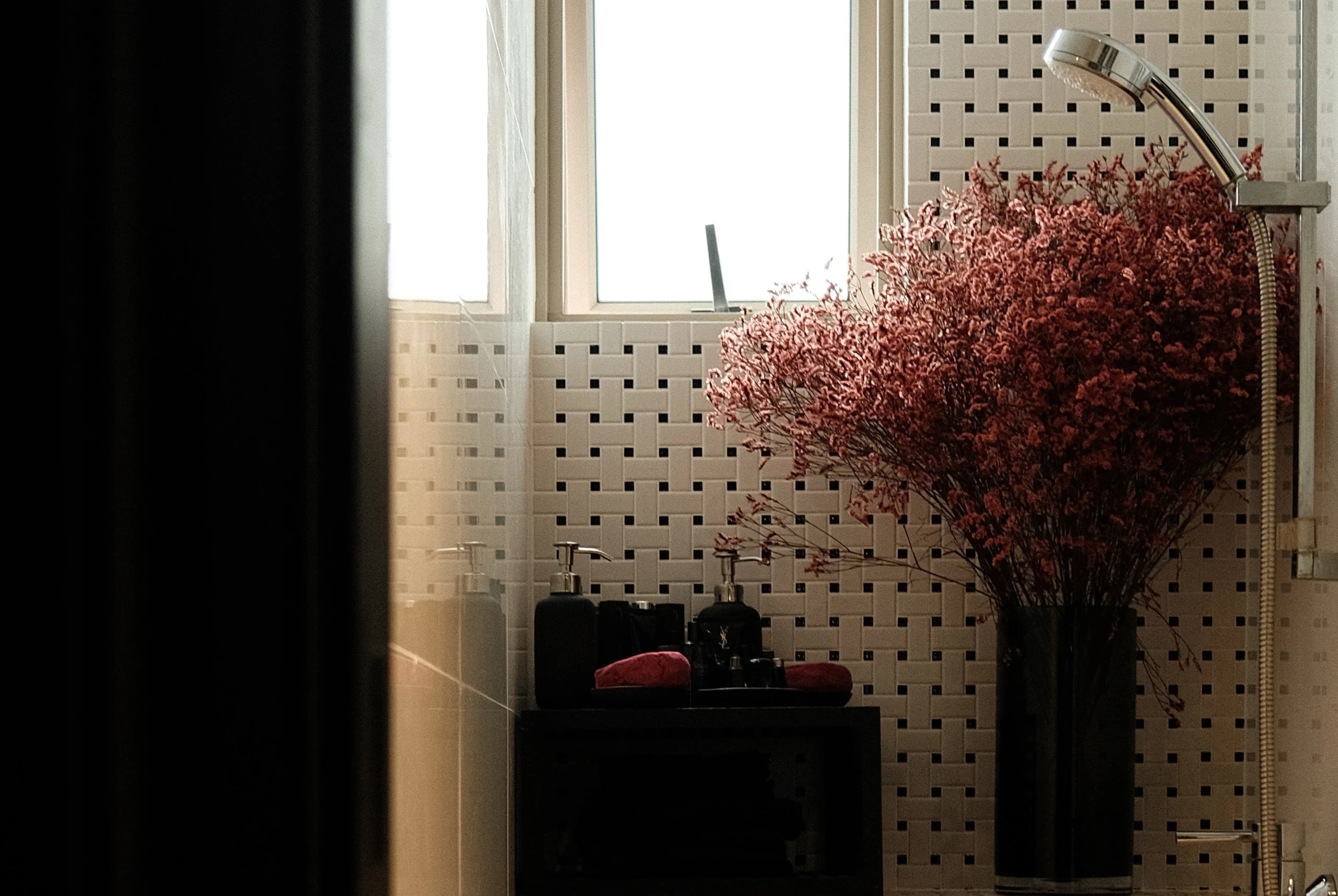 Modern living space with decorative cherry blossom arrangement and perforated feature wall, Singapore home renovation