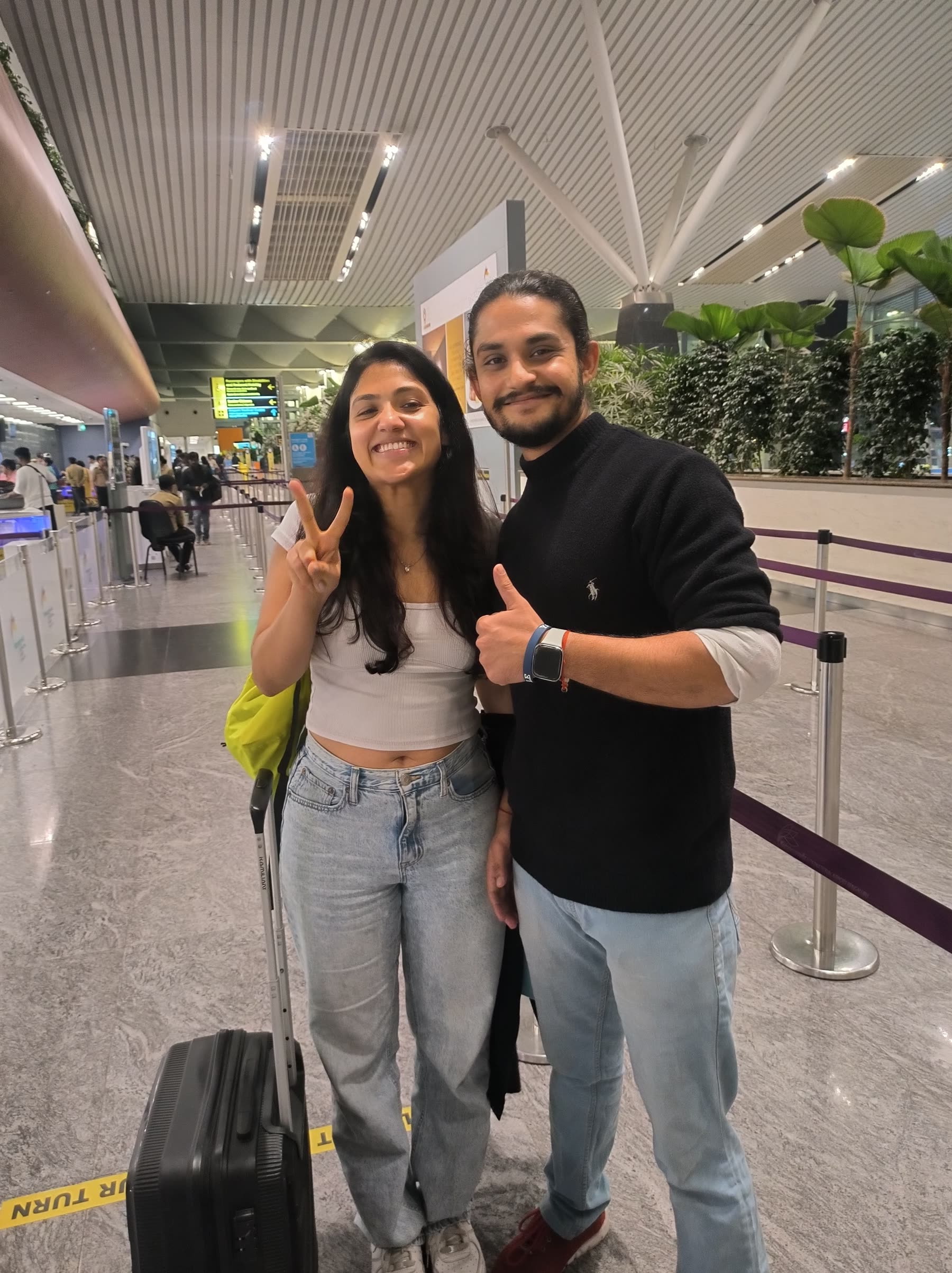 Sarika greeting a friend at an airport