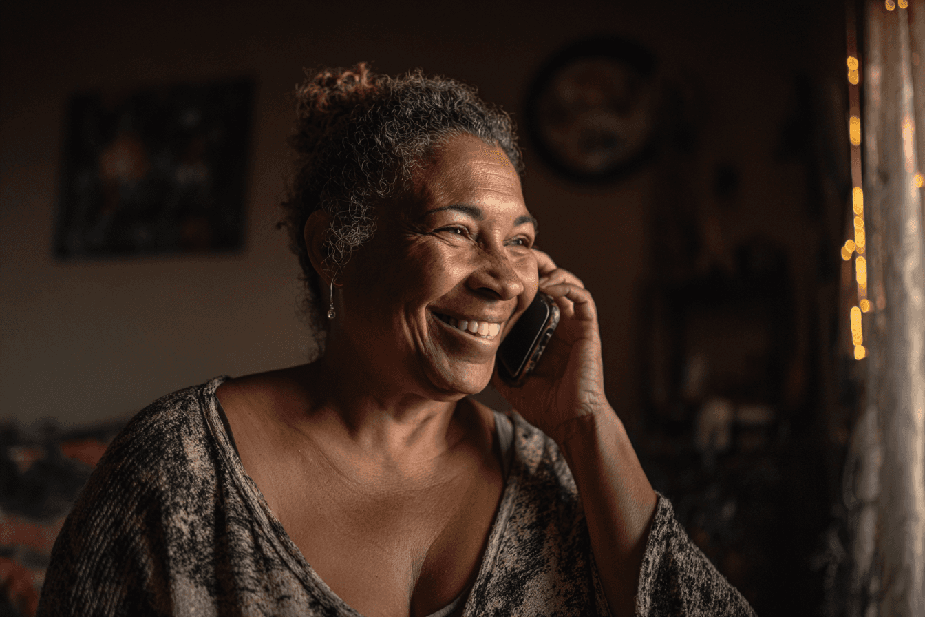 a family member, female, 40s, on her cell phone in her mother's home, smiling