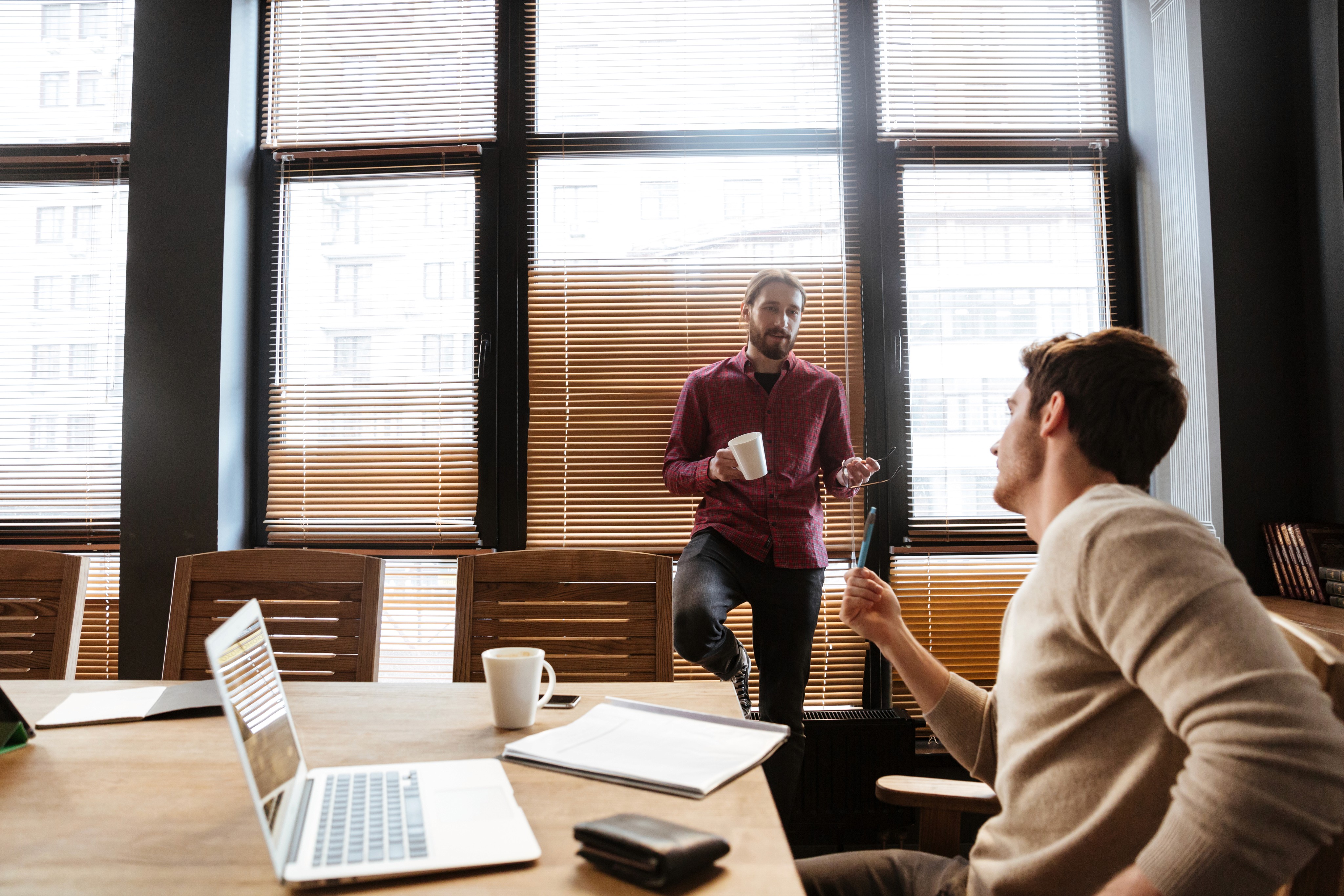 Two young colleague talking with each other