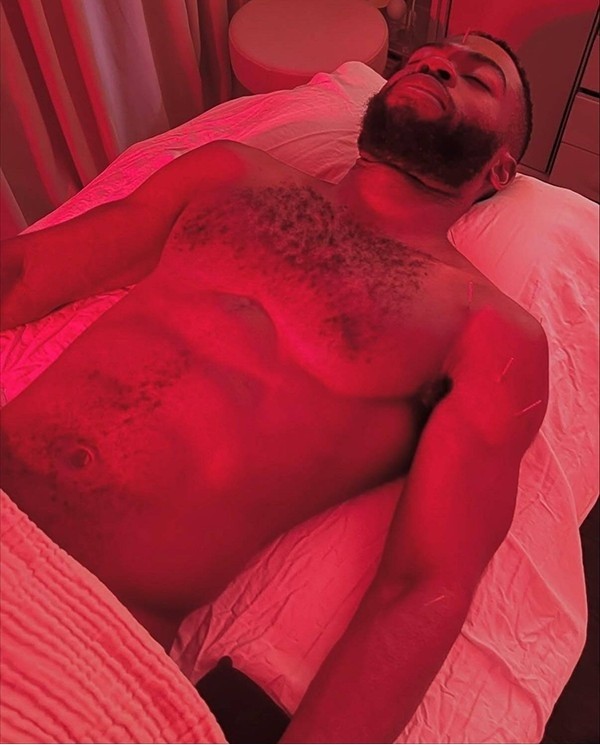 Man receiving red light therapy while resting calmly