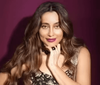 Sara is a client smiling to the camera happily