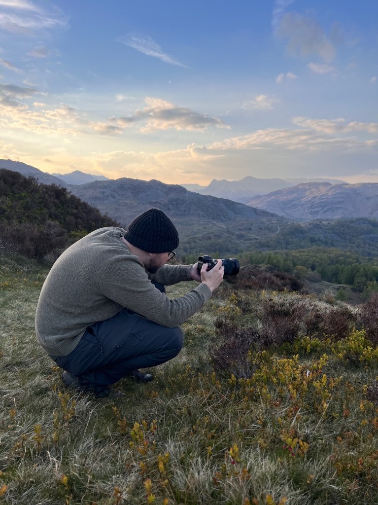 Martin crouched down taking a low-angle photo.