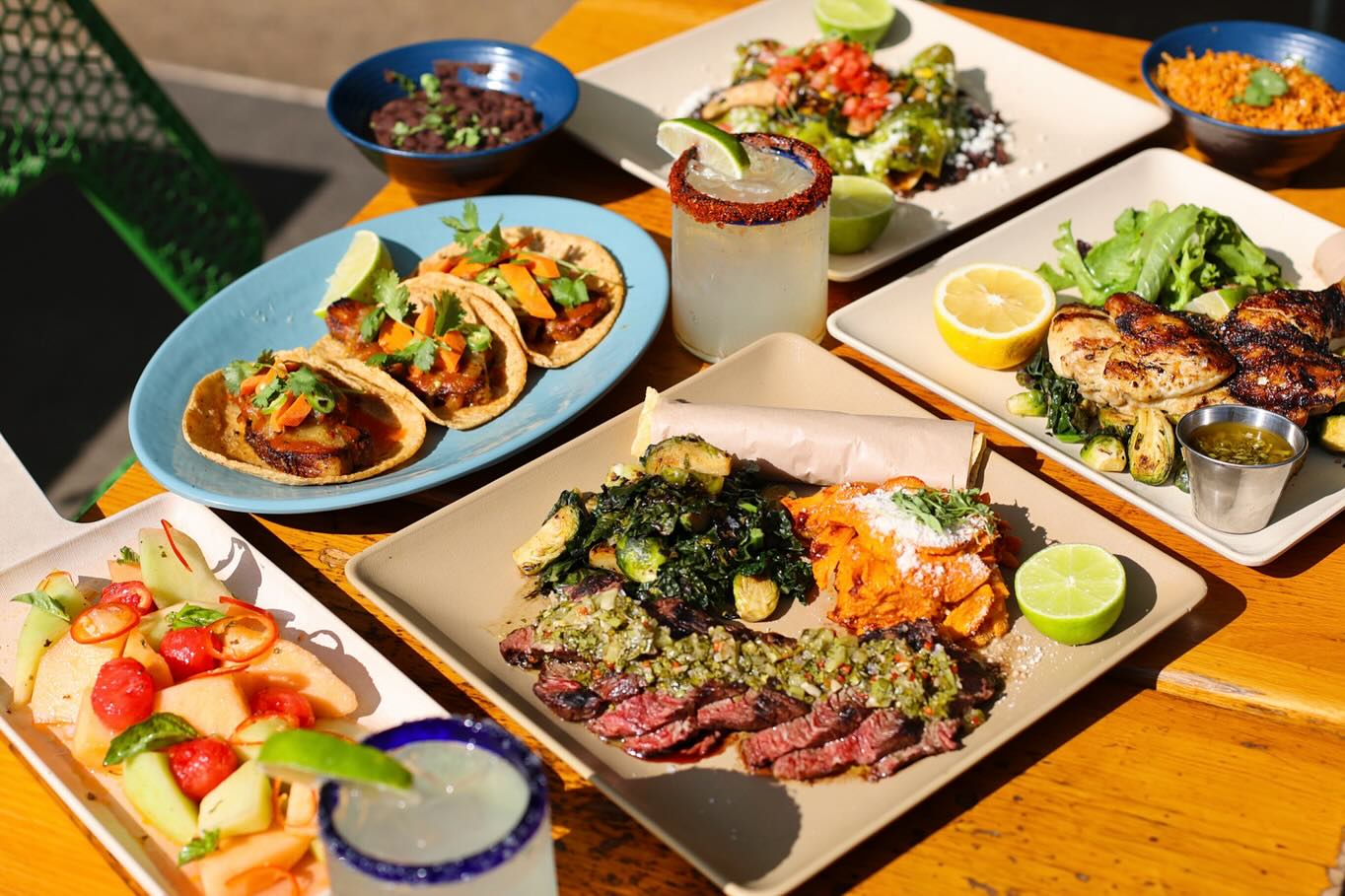 A colorful display of Blue Plate Taco’s signature dishes, including grilled fish tacos, seafood ceviche, and house-made guacamole, showcasing the vibrant flavors of Baja California.