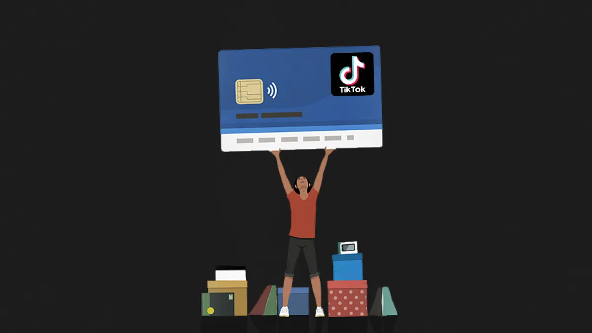holding a tiktok card - TikTok Social Commerce