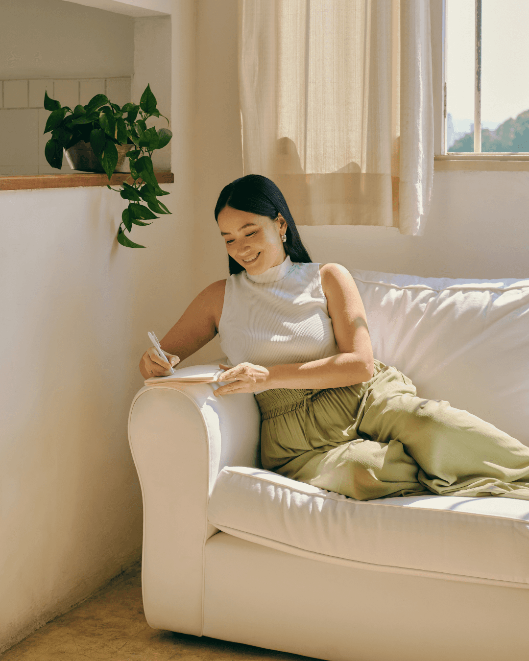 man holding forehead under sunset
