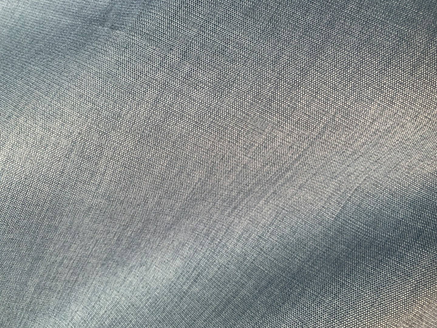 The close weave of a pale linen shirting