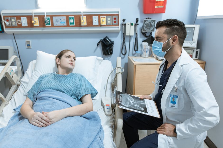 Doctor and patient reviewing a reproductive health chart during a consultation.