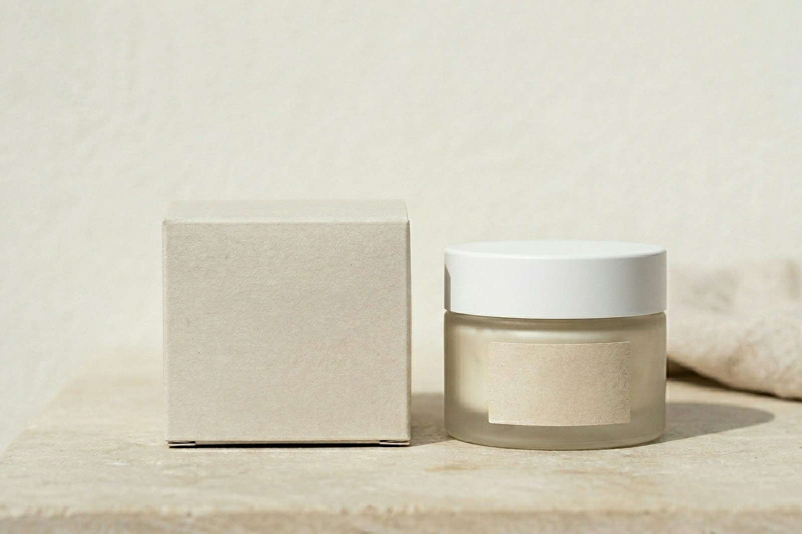 Unlabeled cream jar beside a small box