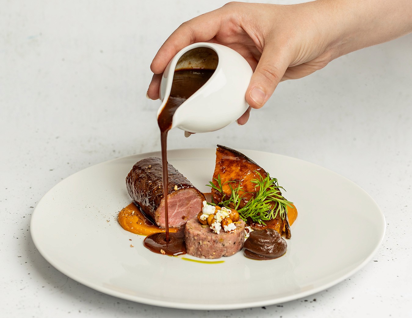 Seared Lamb Loin, maple-roasted squash, spiced crispy chickpeas, black garlic & ash