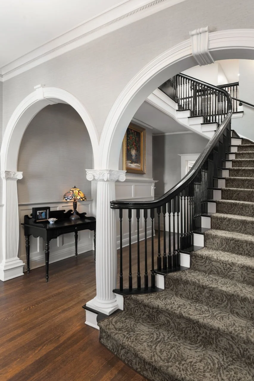 grand staircase with arched columns